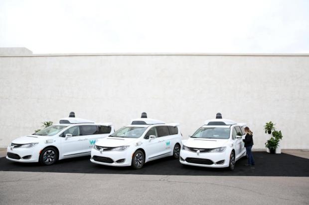 A Waymo employee checks one of three self-driving Chrysler Pacifica minivans on display during a demonstration in Chandler, Arizona on  Nov 29, 2018. (Reuters photo)
