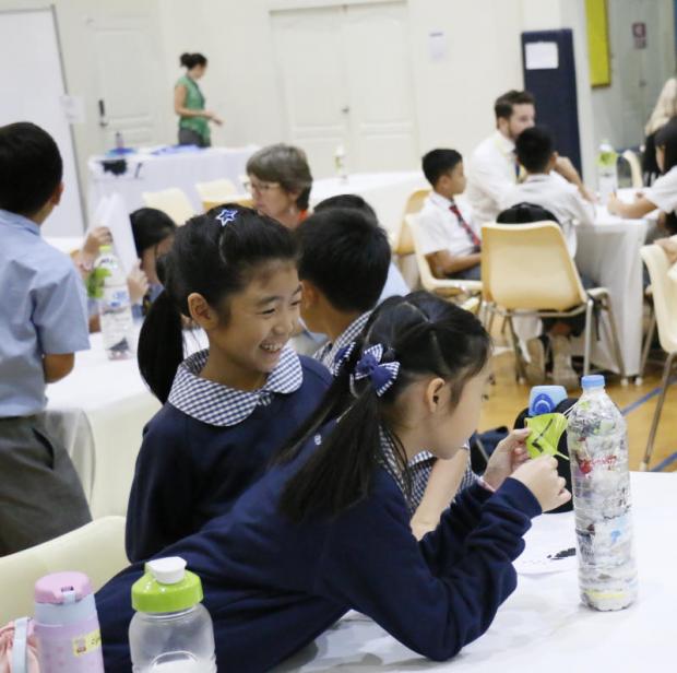 Building a greener future: Children fascinated by Eco-bricks — bottles stuffed with waste plastic which are strong enough to build with.