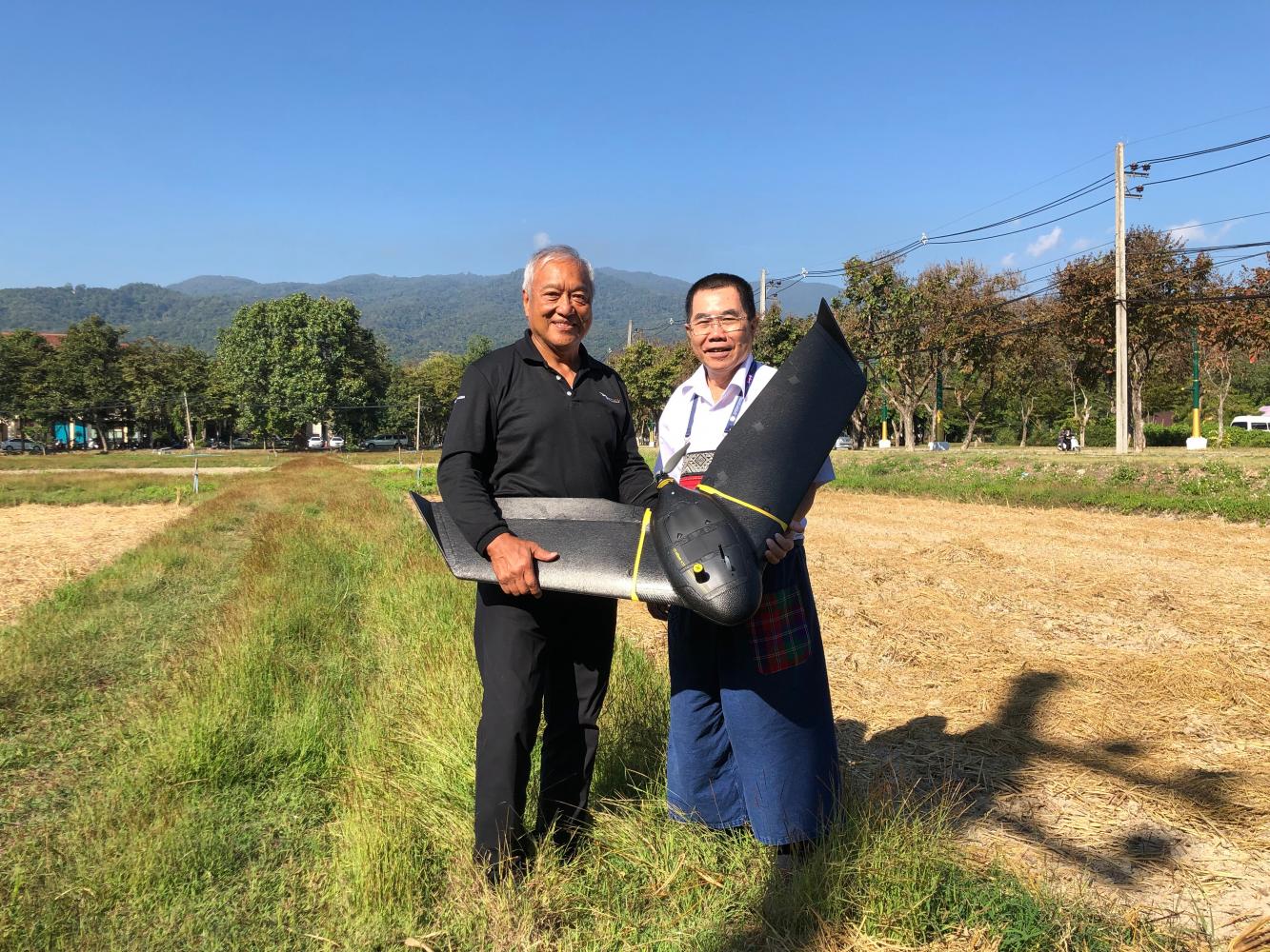 Mr Vivatvong (left) holds a fixed-wing drone from SenseFly.