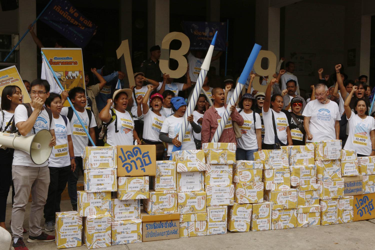 Civic groups stand behind boxes containing signatures backing a draft bill seeking to repeal the military regime's orders and announcements.Pornprom Satrabhaya Civic groups stand behind boxes containing signatures backing a draft bill seeking to repeal the military regime's orders and announcements.Pornprom Satrabhaya