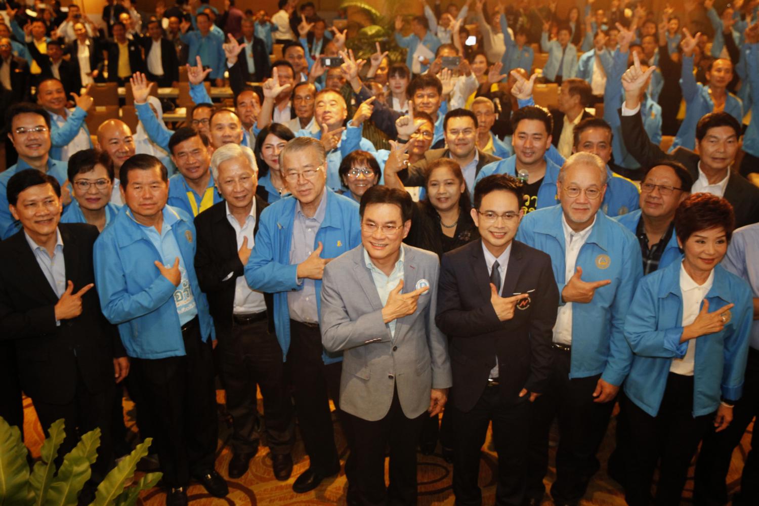 old is new again: Democrat leader and Commerce Minister Jurin Laksanawisit, middle, poses for a group photo with party members who gathered yesterday in Bangkok to brainstorm ideas to strengthen the 73-year-old party.