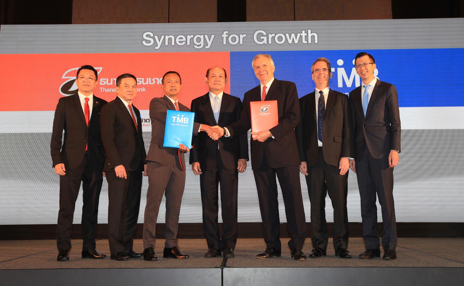 In this picture from Feb 27, 2019, Suphadej Poonpipat, third left, chairman of the executive committee of TBank, and Philippe Damas, third right, chairman of executive directors at TMB, are at the merger signing ceremony. Somchai Poomlard
