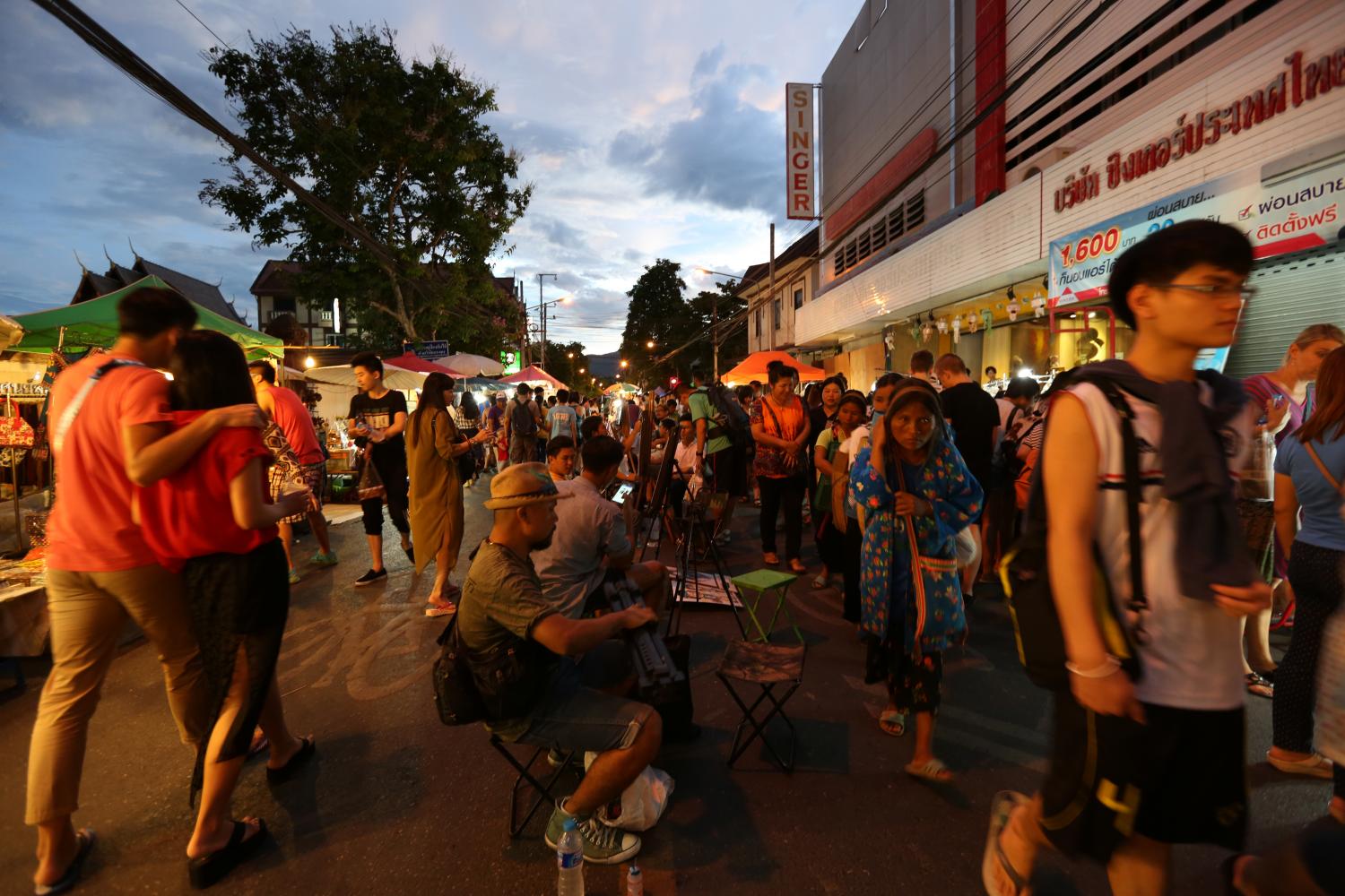 People walk and shop on the packed Tha Pae Walking Street in Chiang Mai. (Bangkok Post photo)