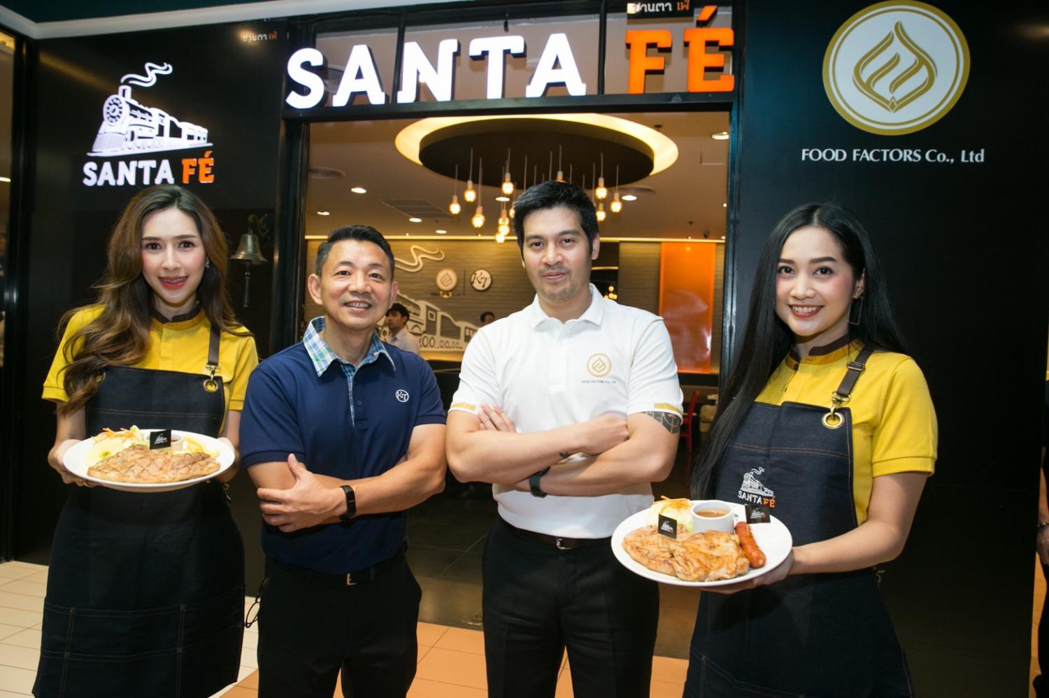 Mr Piti, second right, and Surachai Chananudej, chief executive of KT Restaurant Co, second left display some menu items from Santa Fe eatery.