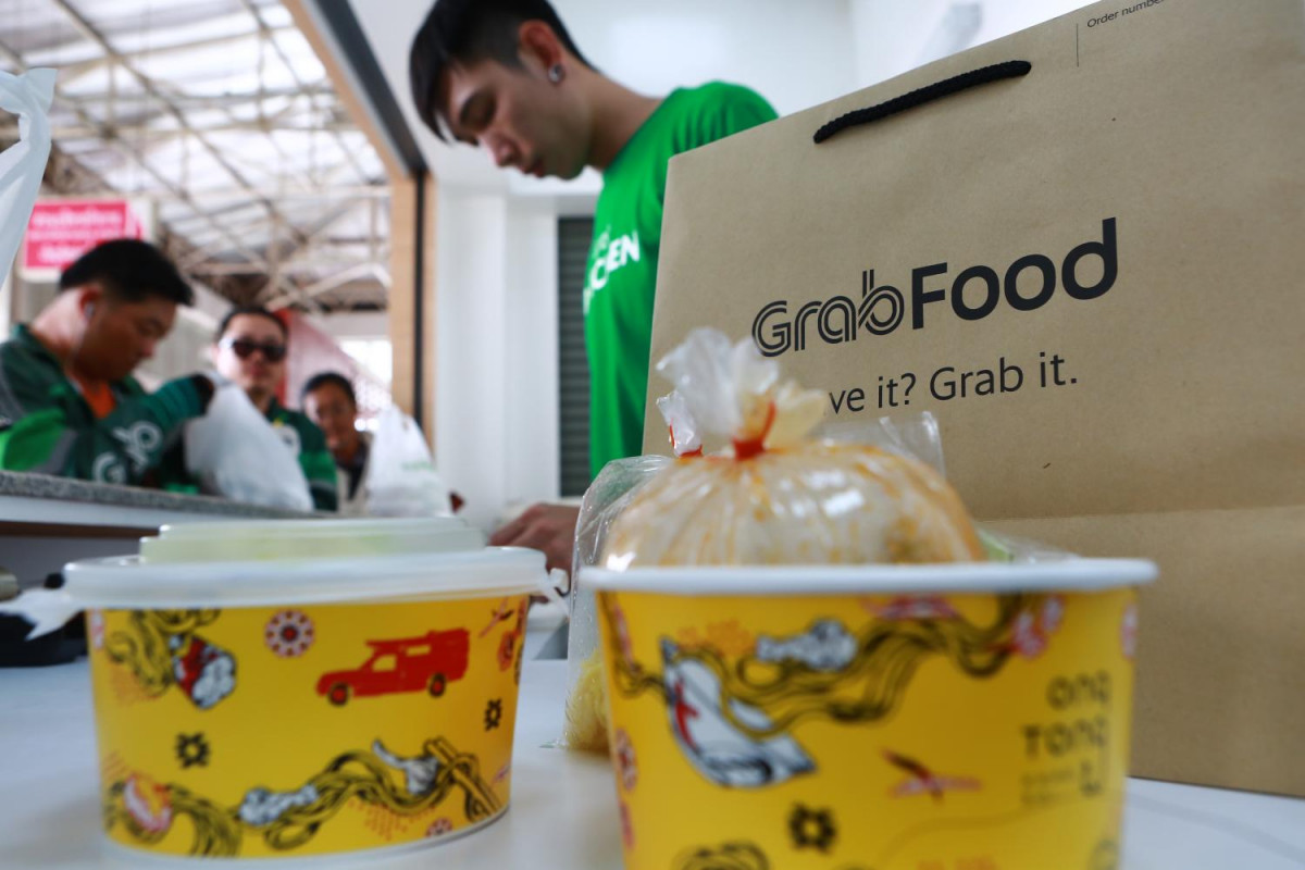 Bangkok Post - Grab, Get duke it out over food delivery