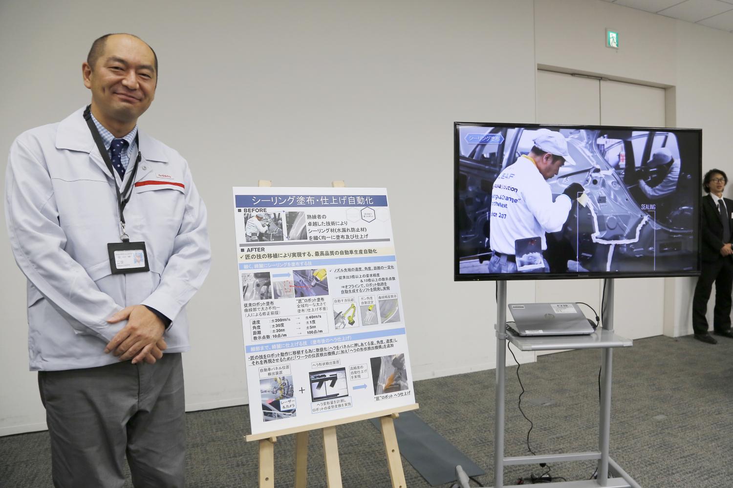 Engineer Makoto Yamada talks to reporters about using robotics for sealing as part of Nissan Motor Corp's new production methods during a press conference at the company's headquarter in Yokohama on Thursday. (AP photo) Engineer Makoto Yamada talks to reporters about using robotics for sealing as part of Nissan Motor Corp's new production methods during a press conference at the company's headquarter in Yokohama on Thursday. (AP photo)