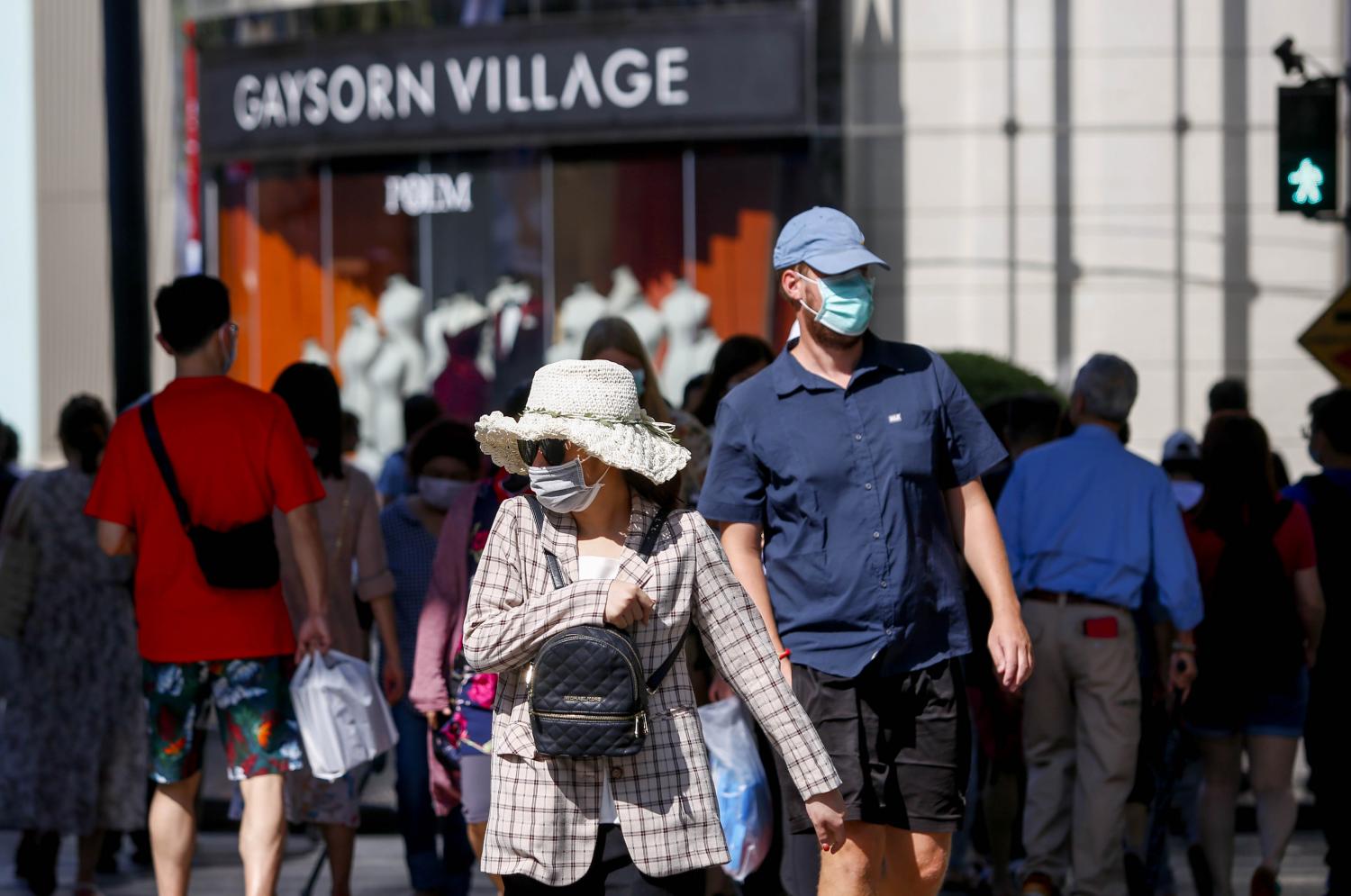 Tourists wear masks at the Ratchaprasong intersection. The tourism sector has been hit hard by the coronavirus outbreak. PATTARAPONG CHATPATTARASILL