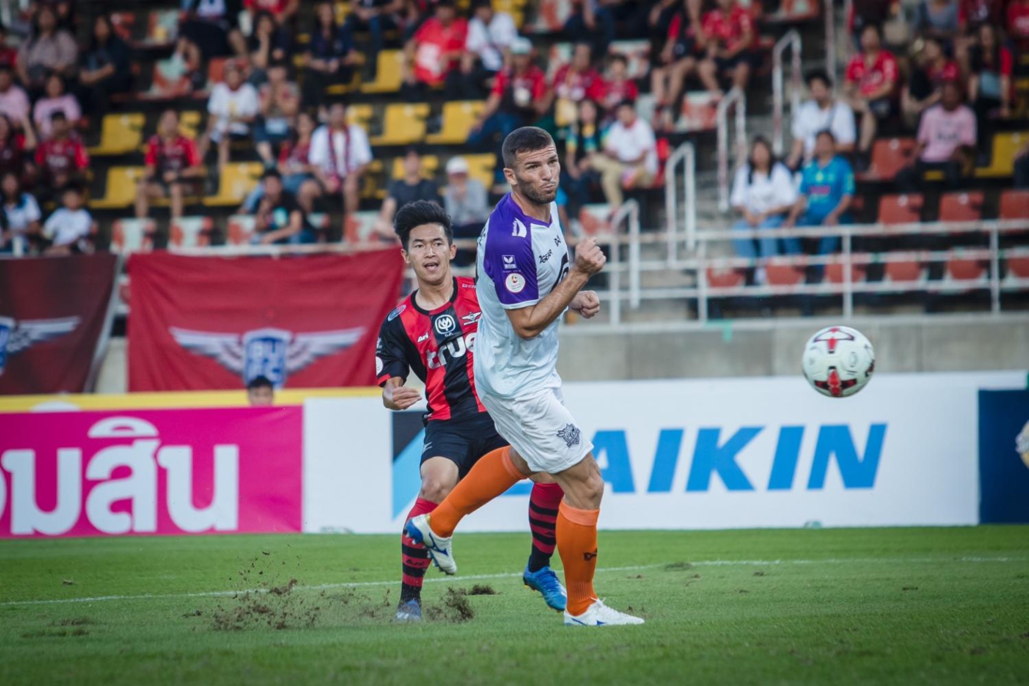 True Bangkok United forward Nattawut Suksum, left, scores their first goal against PT Prachuap.