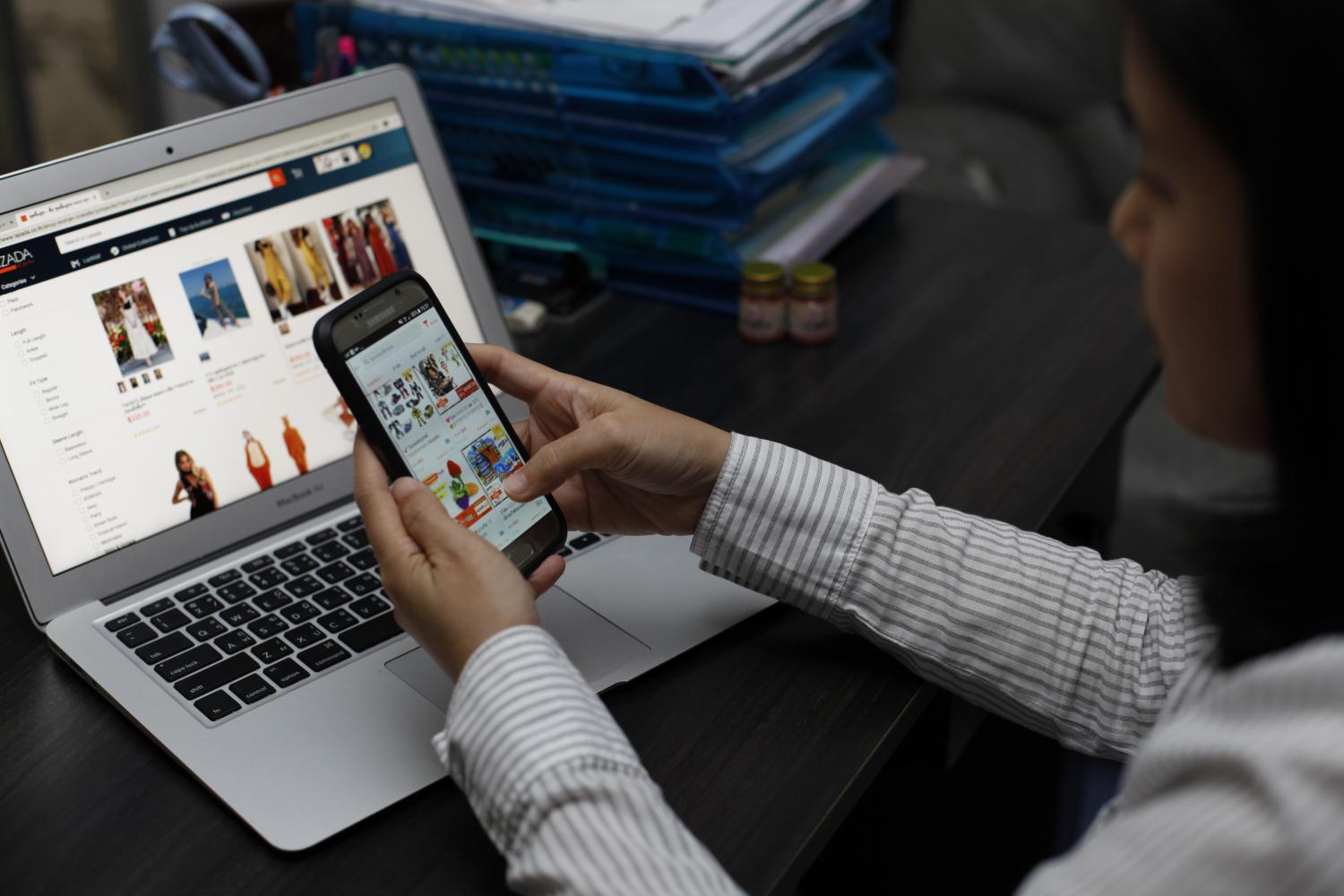 An online shopper browses products offered on an e-commerce platform in Thailand. VARUTH HIRUNYATHEB