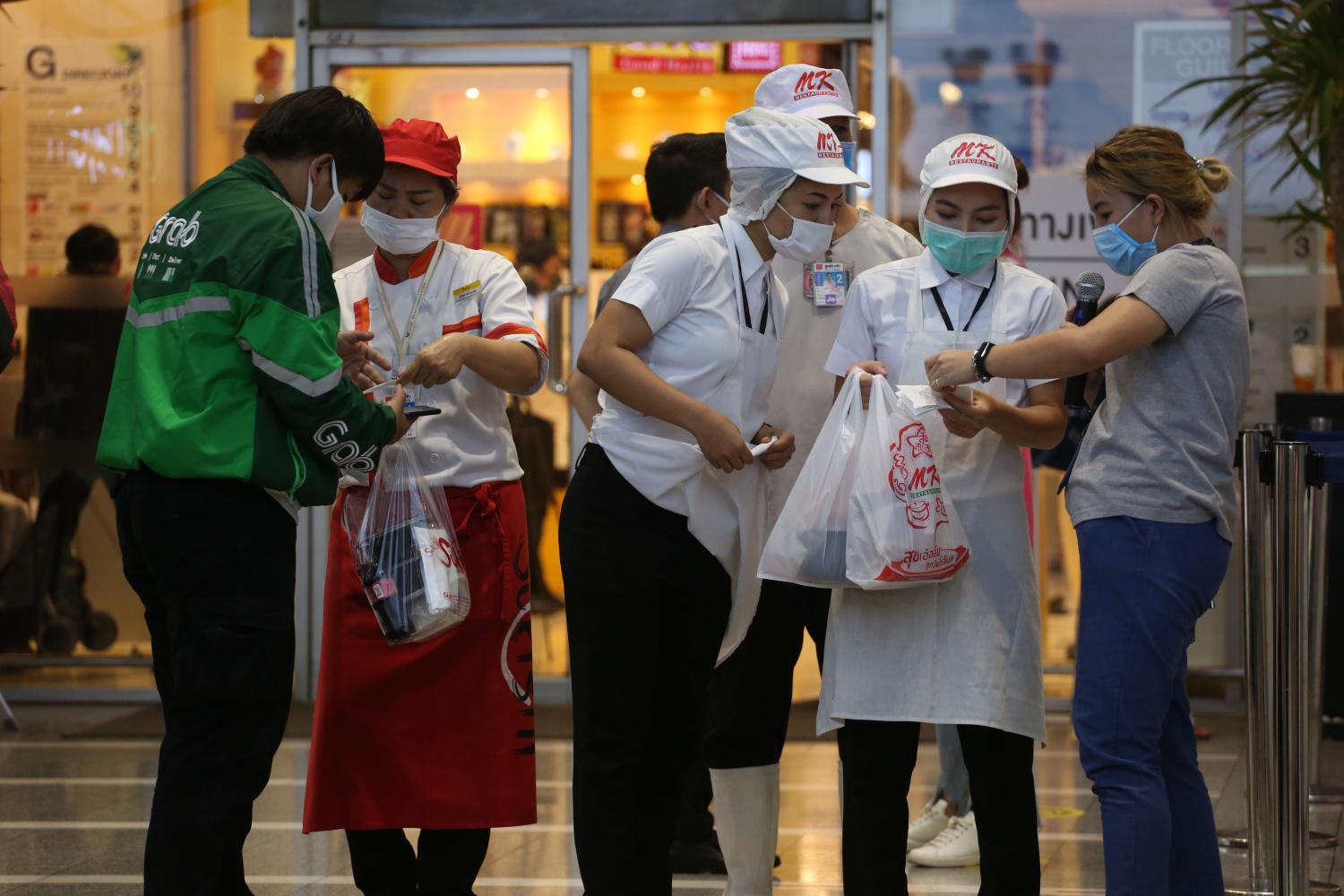 Restaurants at The Mall Bang Kapi see a rise in home delivery orders after their dining zones were ordered closed for 22 days as part of the government's efforts to contain the spread of the new coronavirus outbreak. Varuth Hirunyatheb