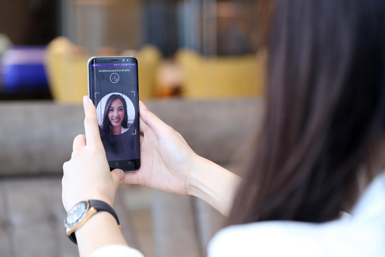 A mobile screen displays SCB's digital know-your-customer feature, allowing new bank accounts via facial recognition.