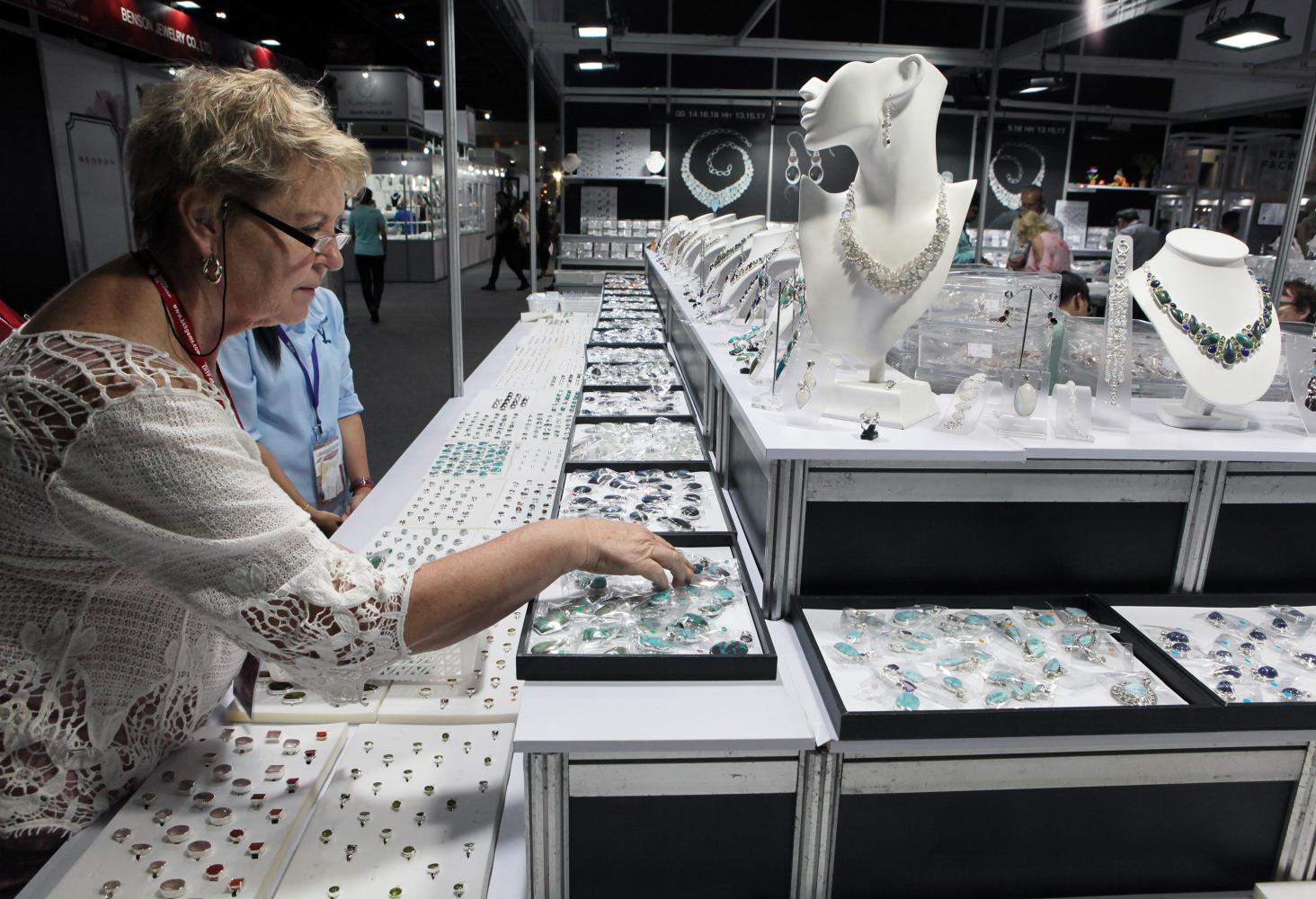 A visitor looks at collections presented at a jewellery fair. Jewellery makers are asking for 50 billion baht in financial support. (Photo by Tawatchai Kemgumnerd)