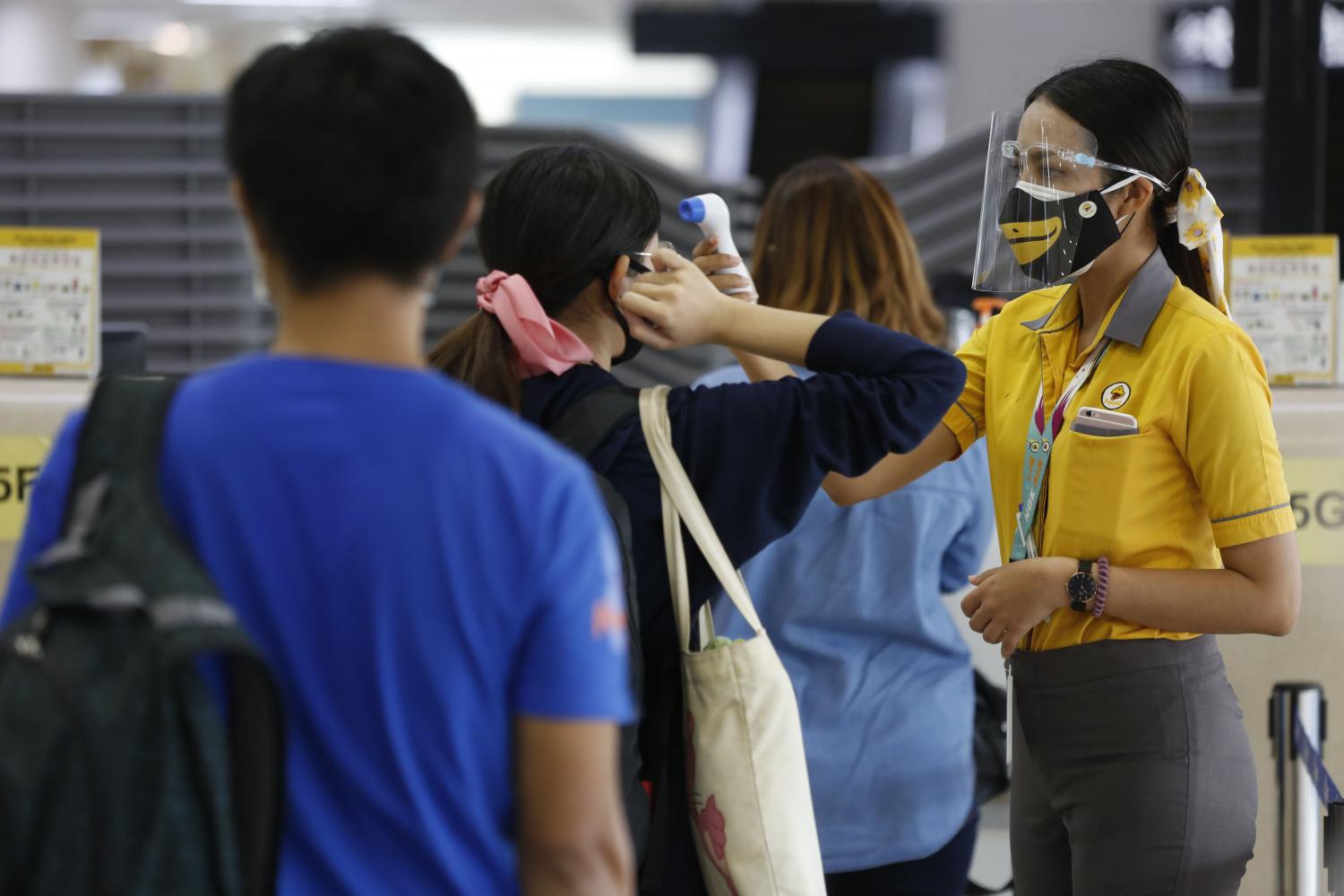 Nok Air conducts screening of outbound passengers at Don Mueang airport. The aviation industry in Thailand is projected to shrink this year as fewer people fly. (Photo by Pornprom Satrabhaya)