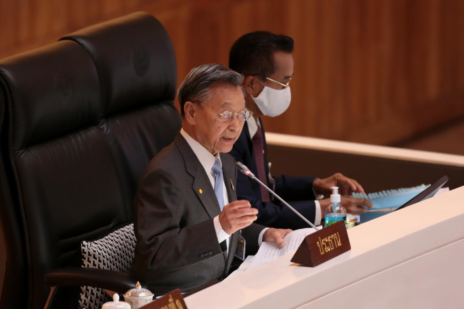 House Speaker Chuan Leekpai, left, responds to criticism about the Covid-19 fund bill made by Move Forward Party MP Amarat Chokepamitkul, right, during its first reading in parliament on Thursday. Chanat Katanyu