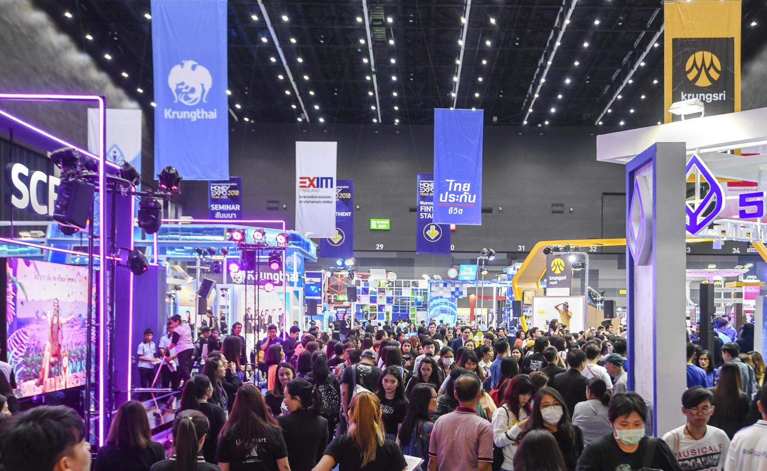 Customers browse financial services at a Money Expo. The banking industry has been focusing on helping customers via several methods of debt restructuring.