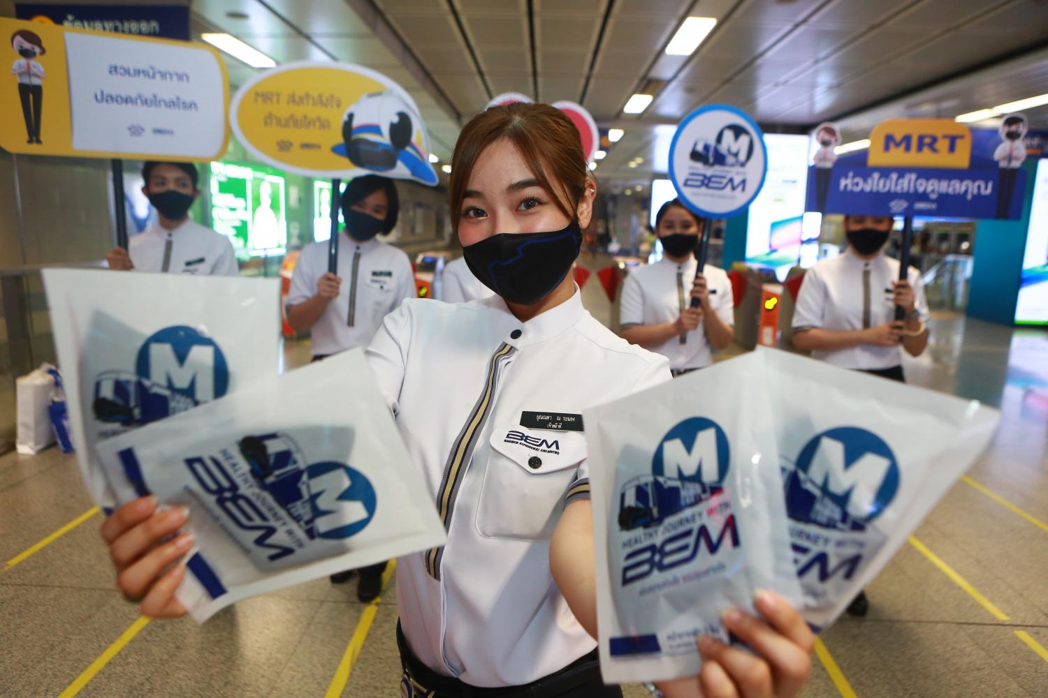 A group of BEM employees showcase the company's MRT safety campaign aimed at educating the public about Covid-19. (Photo by Somchai Poomlard)