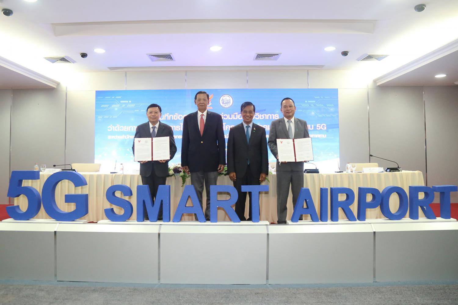 From left  Mr Takorn, NBTC chairman Gen Sukit Khamasundara, Mr Thaworn and Department of Airports director Tavee Kerdsamang display the 5G Smart Airport MoU.