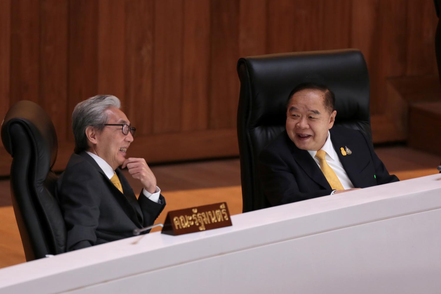 Somkid Jatusripitak, left, and Gen Prawit Wongsuwon, both deputy prime ministers, engage in a light-hearted chat during the first day of the budget bill debate in parliament on Wednesday. The debate took place amid growing tension between Mr Somkid and some MPs in the ruling Palang Pracharath Party, led by Gen Prawit. (Photo by Chanat Katanyu) Somkid Jatusripitak, left, and Gen Prawit Wongsuwon, both deputy prime ministers, engage in a light-hearted chat during the first day of the budget bill debate in parliament on Wednesday. The debate took place amid growing tension between Mr Somkid and some MPs in the ruling Palang Pracharath Party, led by Gen Prawit. (Photo by Chanat Katanyu)