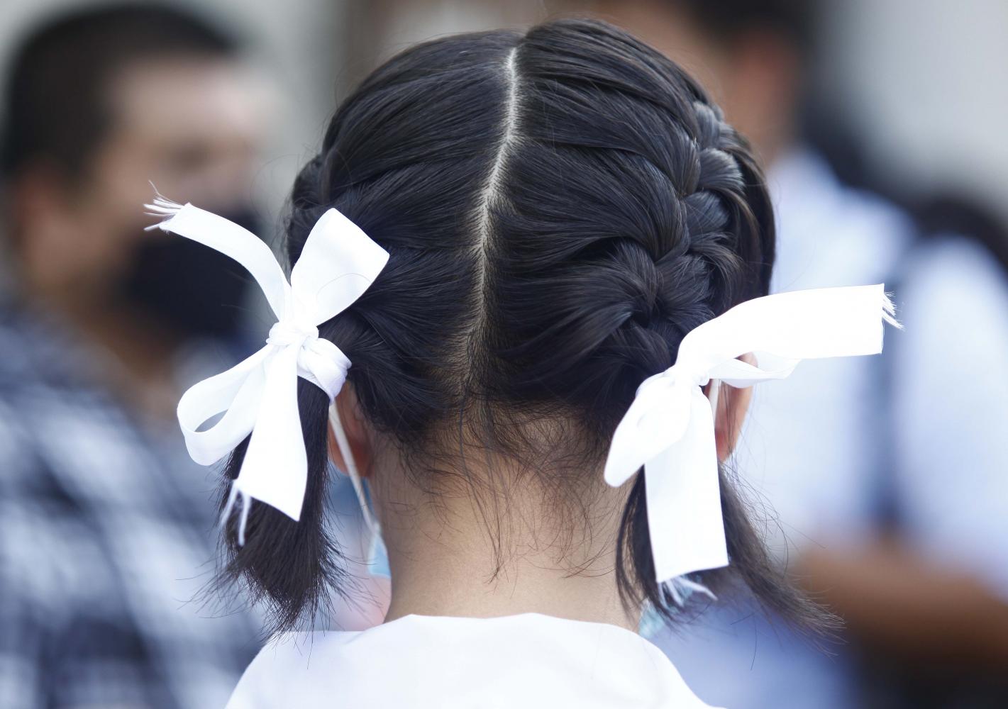 White ribbons are worn by students as a symbol that they stand in unity amid anti-government protests.