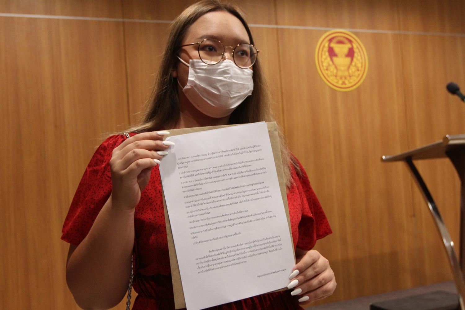 Activist Panasaya Sitthijirawattanakul with the document she submitted. (Photo by   Wichan Charoenkiatpakul)