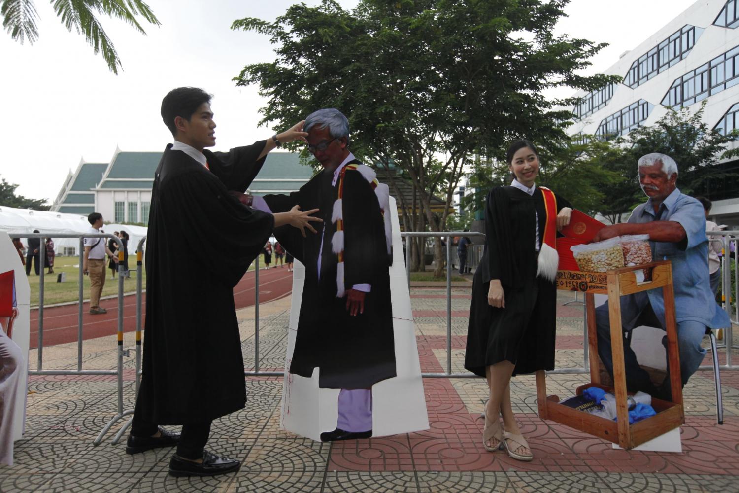 Cardboard critics seen at Thammasat graduation protest