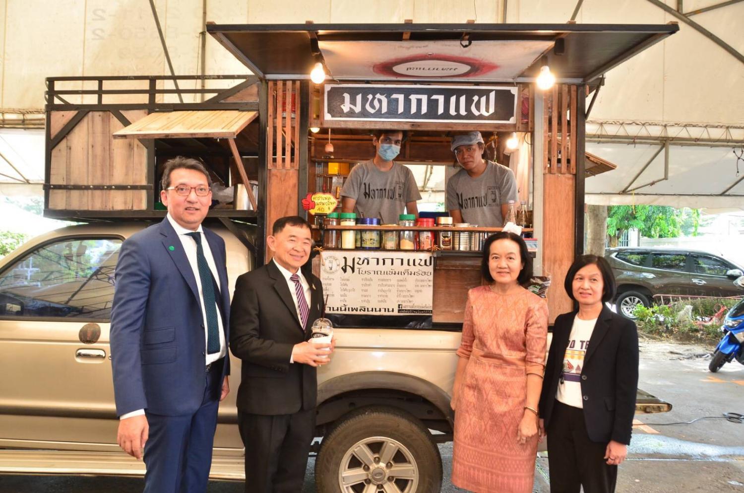 Deputy Commerce Minister Weerasak Wangsuphakijkosol (second from left) presided at the 'Food Truck Mart' fair at Commerce ministry to show the potential and growth of mobile food truck businesses during the Covid-19 crisis.