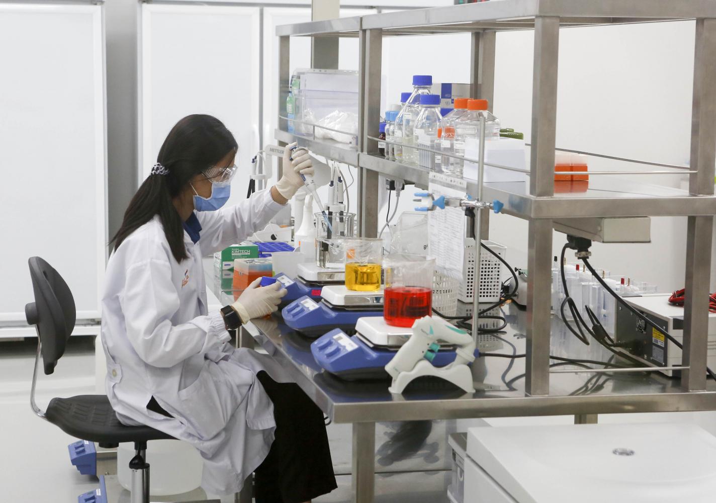 A scientist at the Siam Bioscience Group works to produce Covid-19 test kits. (Photo by Pattarapong Chatpattarasill)