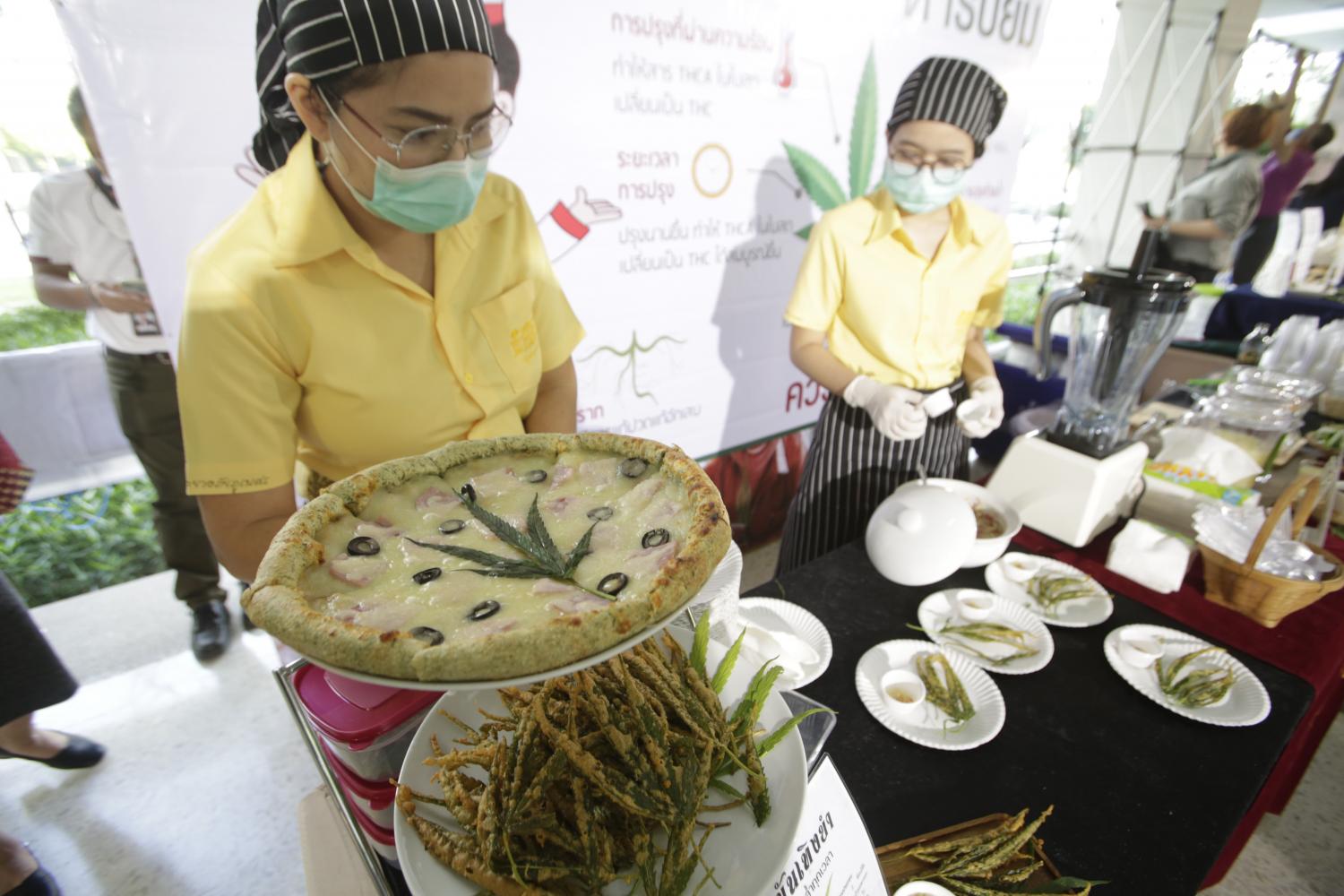 A variety of savoury dishes, including pizza, kaprao and khao yum and drinks, which were made using cannabis as an ingredient are shown here. The dishes were displayed at an event to develop cannabis-mixed recipes. Only parts of the plants grown for medical research in legally permissible locations are used.  (Photos: Pornprom Satrabhaya)