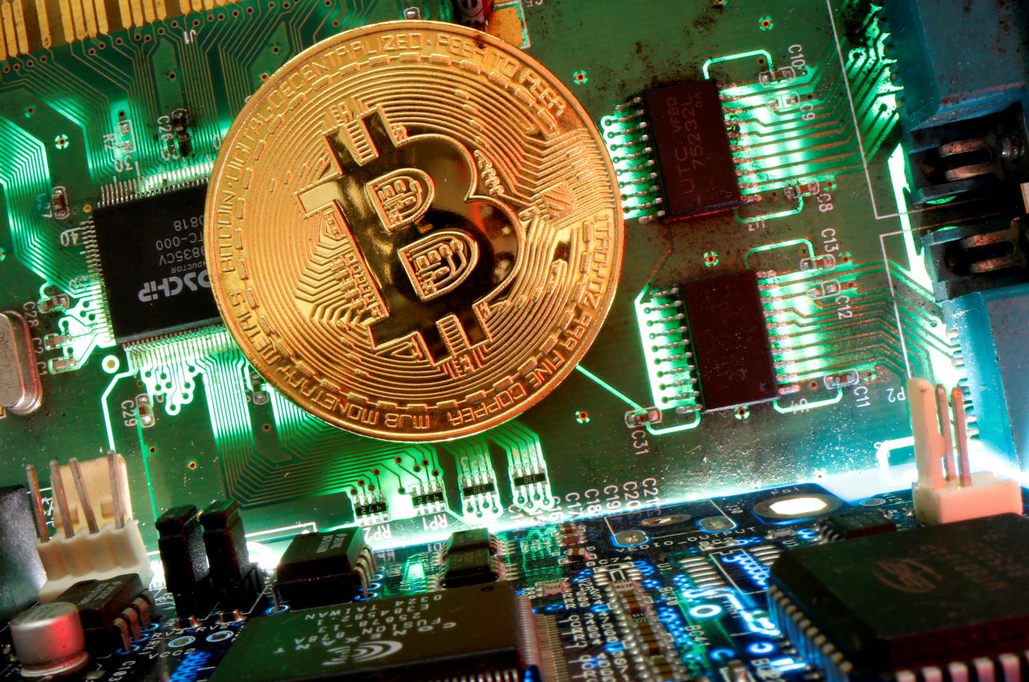 A representation of bitcoin on a motherboard in an illustration. Proposed SEC rules for trading cryptocurrency have Thais upset. (Reuters photo) A representation of bitcoin on a motherboard in an illustration. Proposed SEC rules for trading cryptocurrency have Thais upset. (Reuters photo)