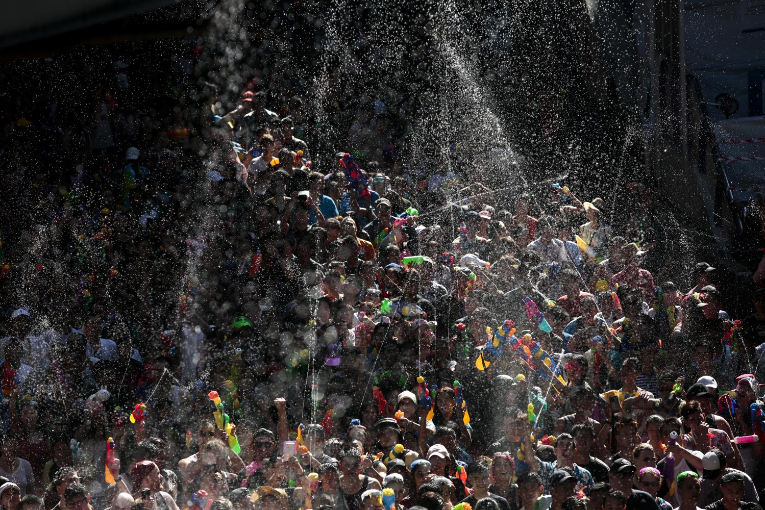 Water spectacular: Silom Road overflows with revellers on the first day of the Songkran festival in 2018. The government has signalled the festival will come back next month with strict measures to curb the spread of Covid-19.