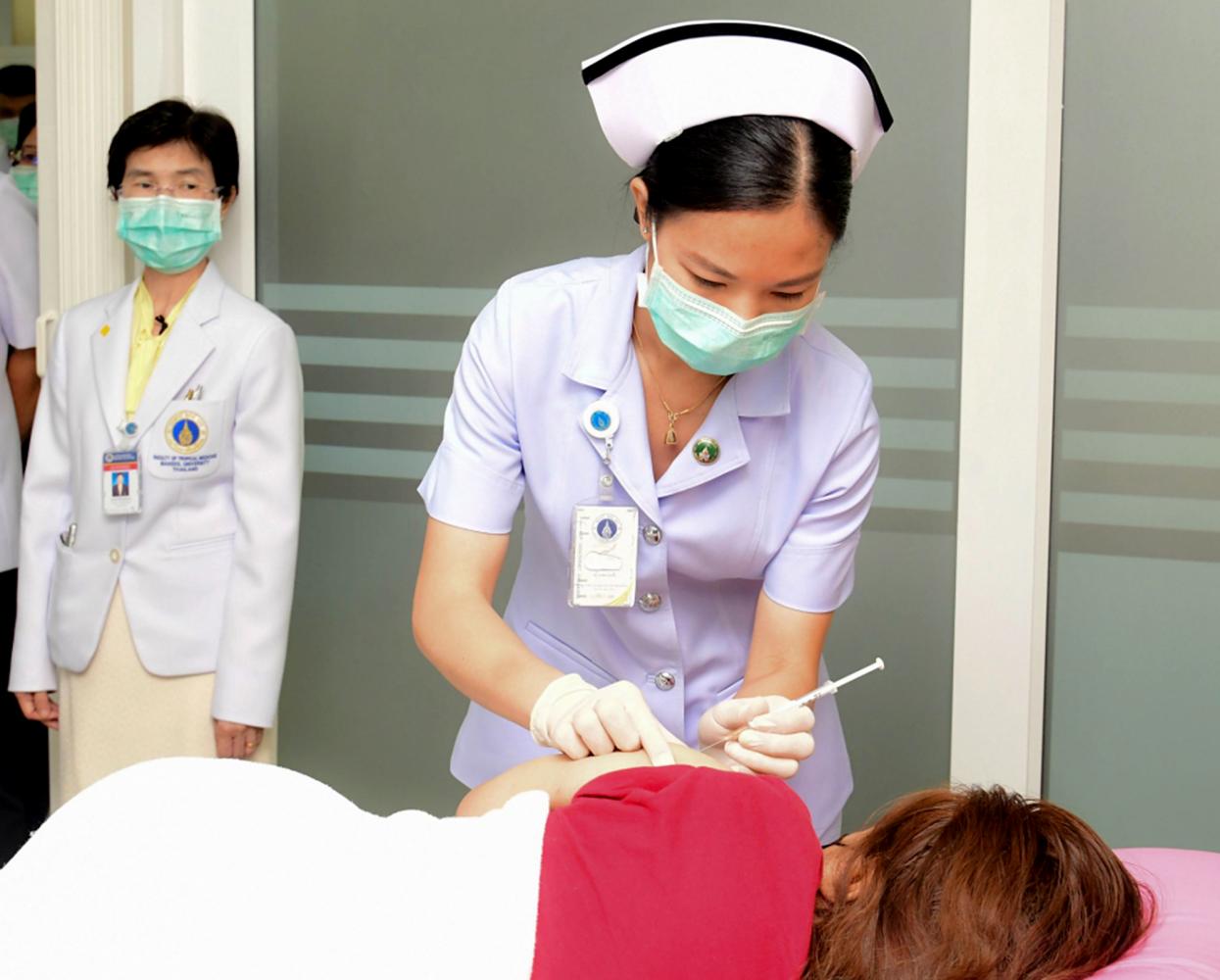 A nurse administers a jab to a volunteer in the country's first human trials of a domestically developed Covid-19 vaccine. The vaccine, consisting of an inactivated virus to trigger immunity, is being developed by the Government Pharmaceutical Organisation using egg-based technology. The Government Pharmaceutical Organisation