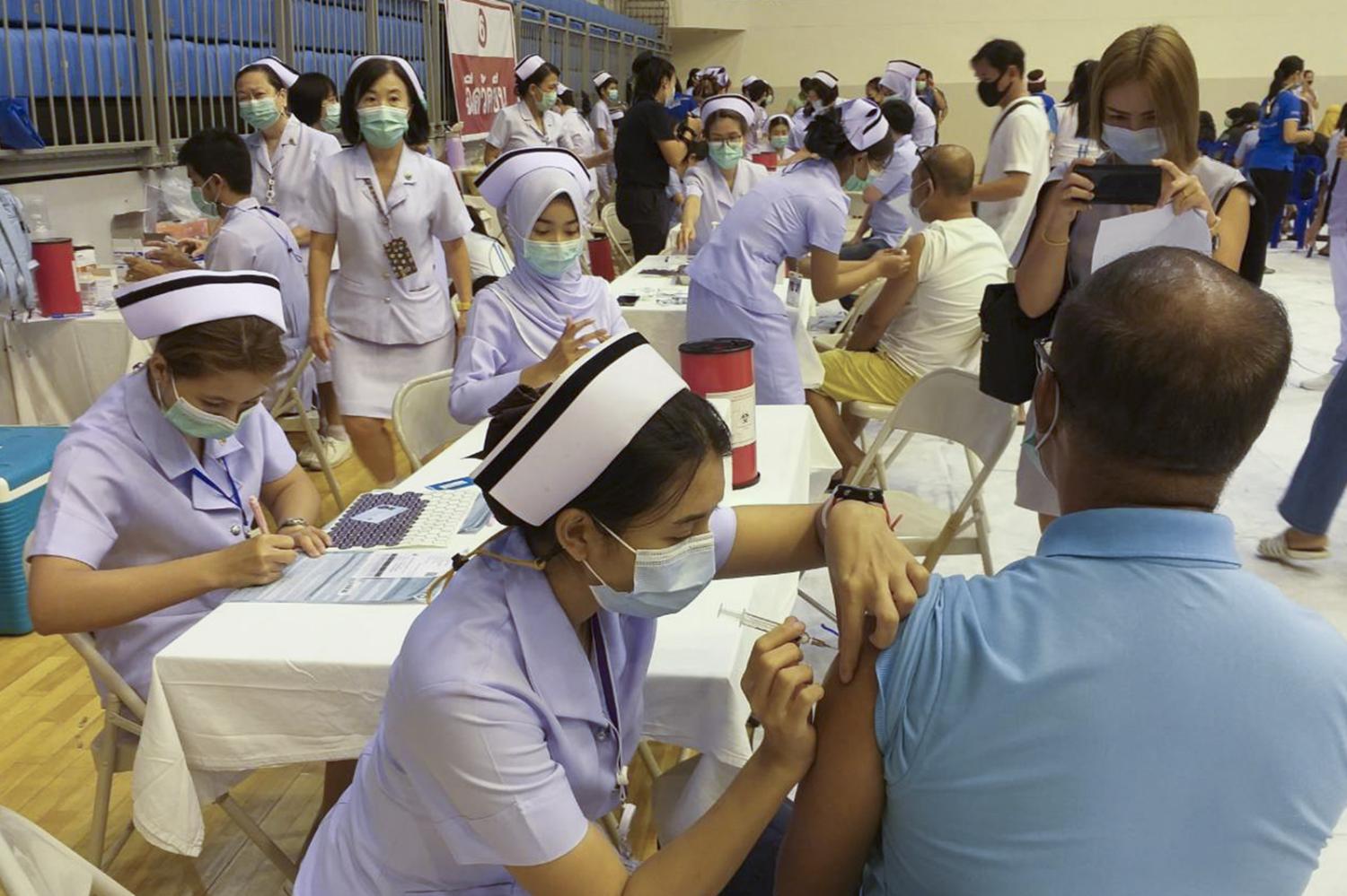 People receive Covid-19 vaccines in Phuket. The island is rushing to vaccinate locals ahead of the reopening initiative slated for July 1. (Photo by Achadthaya Chuenniran)