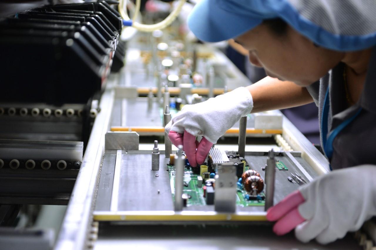 At Delta Electronics in Thailand, robots are used on production lines for automated and precision screwing functions. But human labour is also needed for tasks such as checking component alignment before soldering a printed circuit board. (Photos © Delta Electronics)