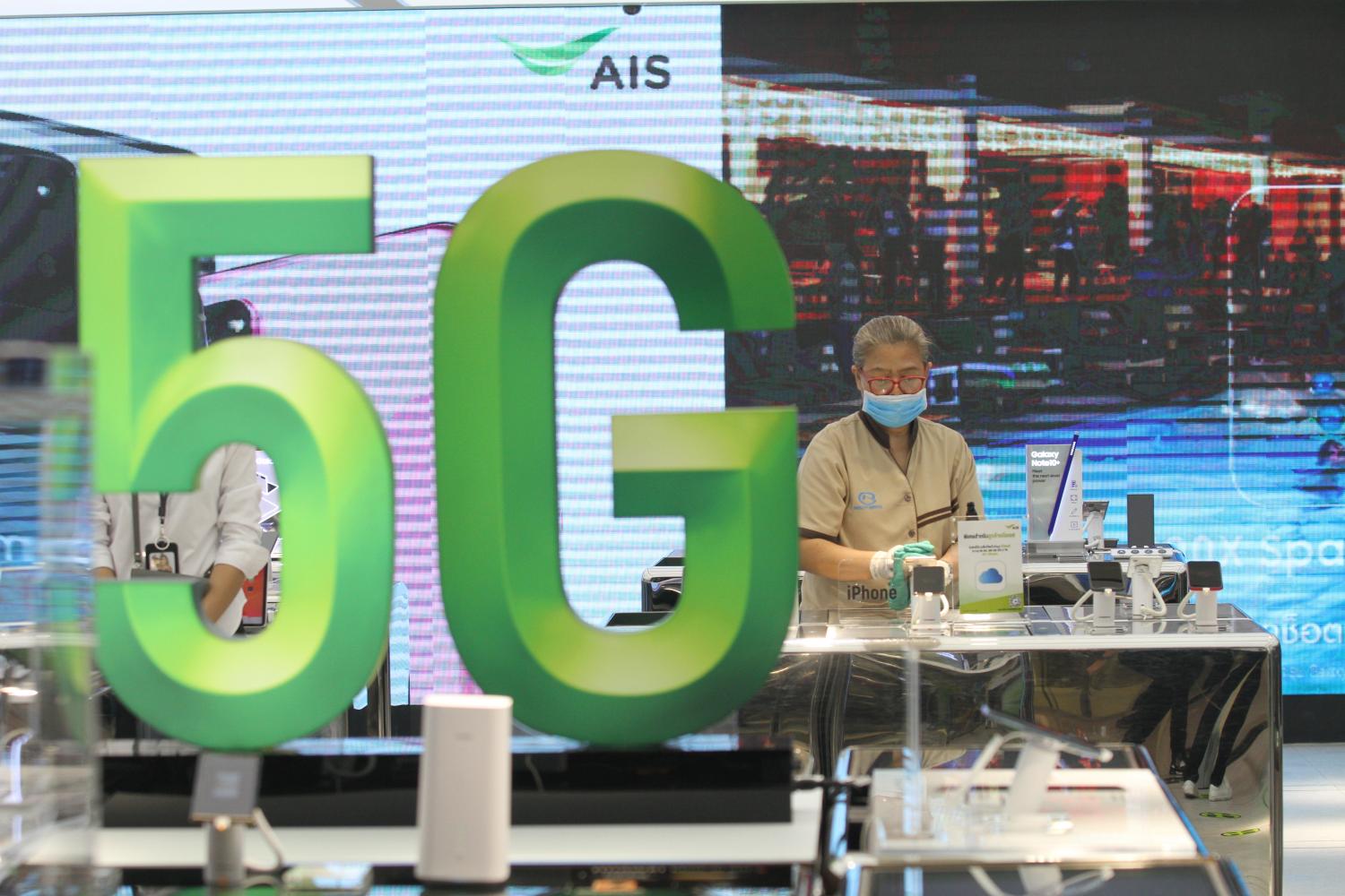 A sign promotes '5G' at the AIS store at CentralWorld shopping mall in Bangkok. Nutthawat Wicheanbut