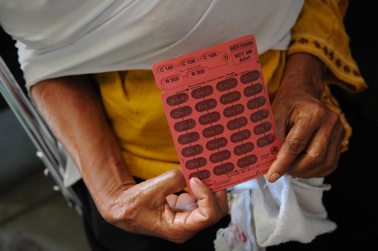 An Indonesian woman affected by leprosy holds up a blister pack of medicine in South Sumatra, Indonesia. (Photo: NLR) An Indonesian woman affected by leprosy holds up a blister pack of medicine in South Sumatra, Indonesia. (Photo: NLR)