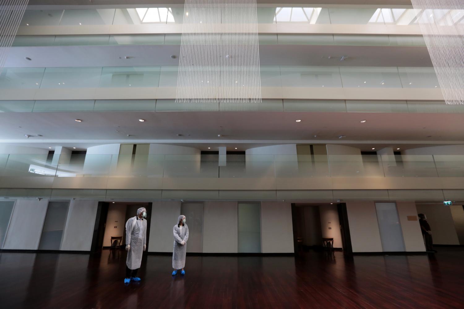 Healthcare workers are seen in PPE suits at the Movenpick BDMS Wellness Resort Bangkok which serves as an alternative state quarantine facility. Chanat Katanyu