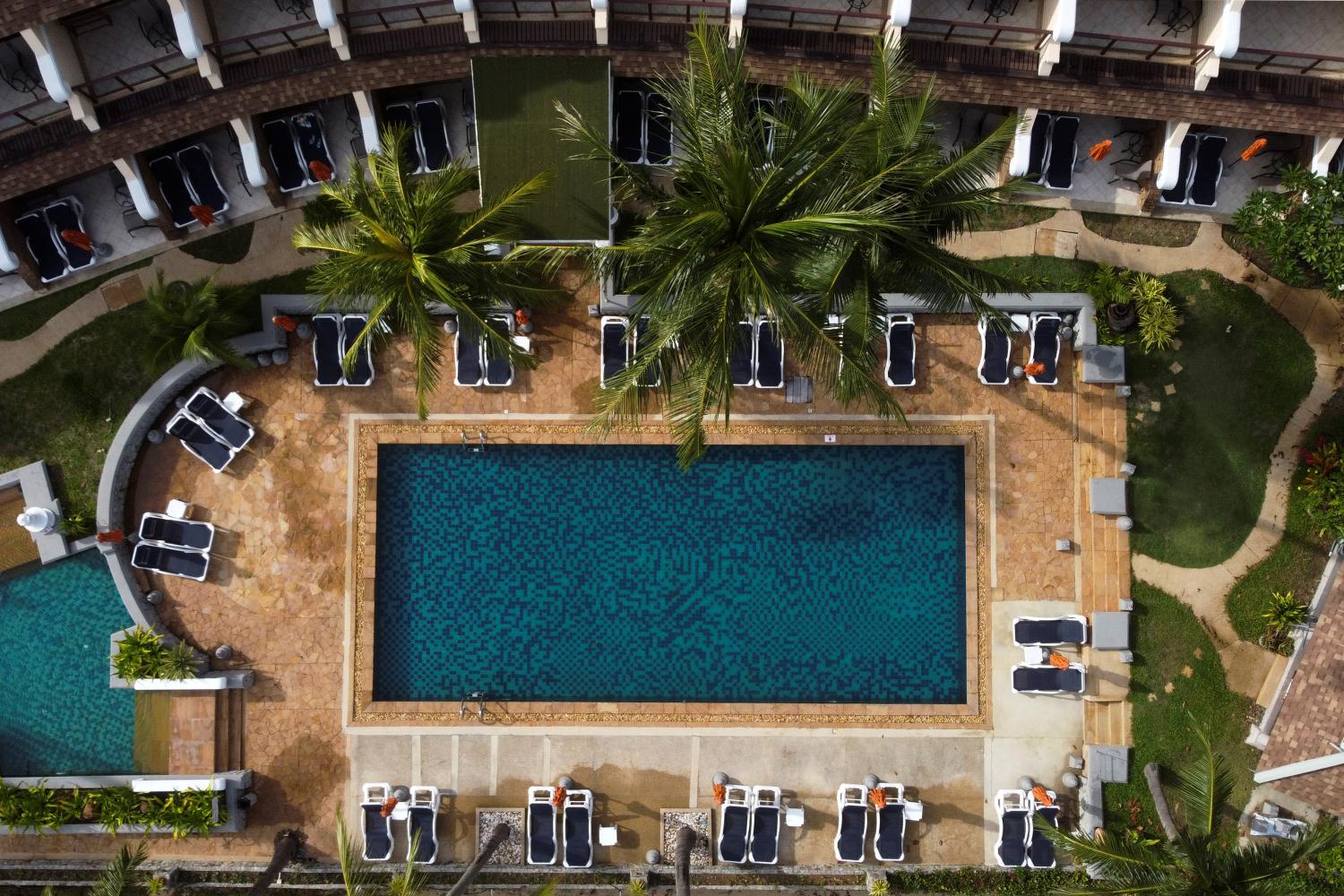 Empty sunbeds are seen around the swimming pool of a hotel which has opened for visitors in Karon, Phuket. (Reuters photo)