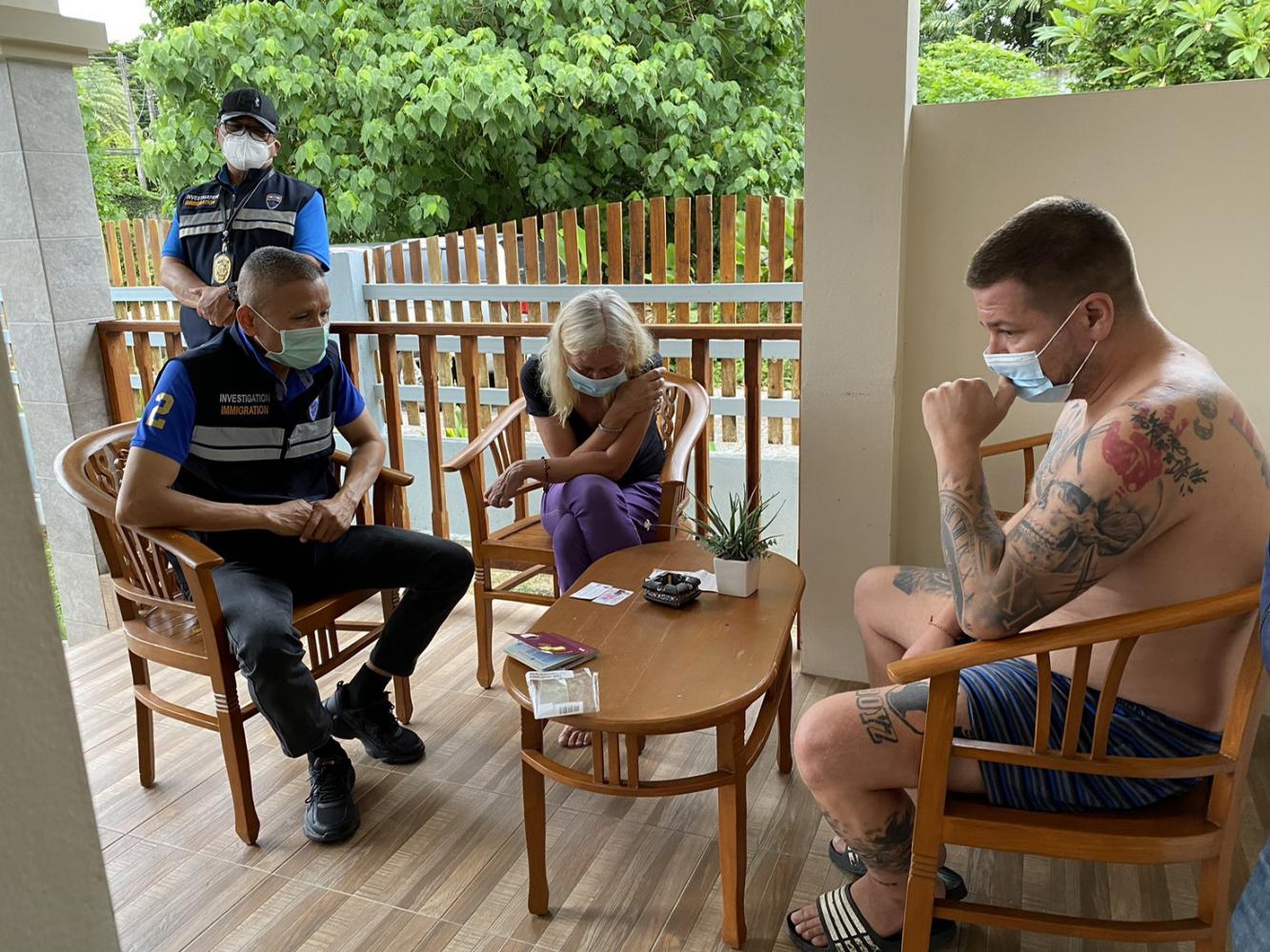 An immigration police officer questions one of two German drug fugitives arrested Tuesday morning. Immigration Bureau photo An immigration police officer questions one of two German drug fugitives arrested Tuesday morning. Immigration Bureau photo