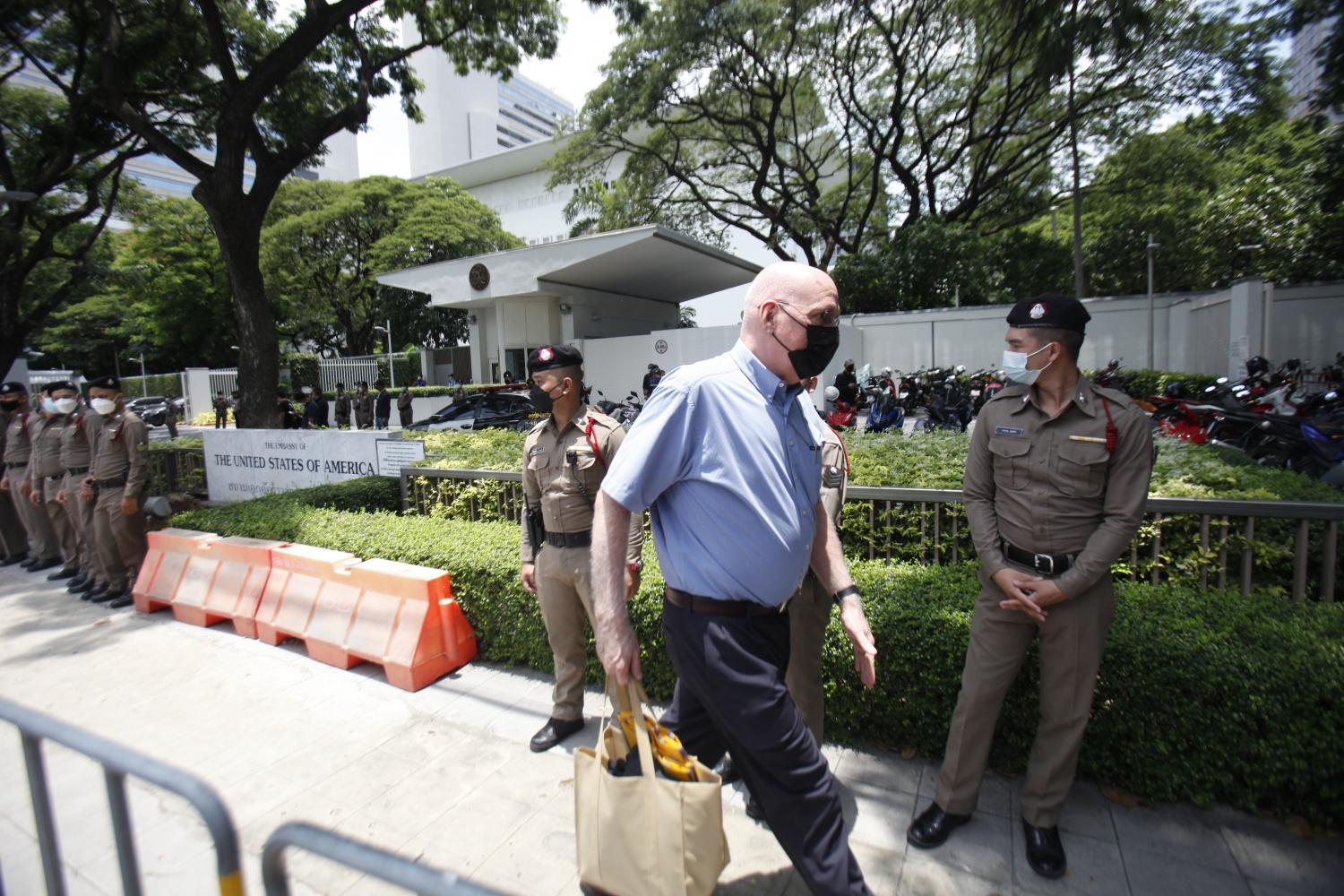 Police stand outside the US embassy in Bangkok ahead of a car mob rally from which anti-government demonstrators plan to submit a petition about the government's allocation of Pfizer vaccine donated by Washington. (Photo: Nutthawat Wicheanbut) Police stand outside the US embassy in Bangkok ahead of a car mob rally from which anti-government demonstrators plan to submit a petition about the government's allocation of Pfizer vaccine donated by Washington. (Photo: Nutthawat Wicheanbut)
