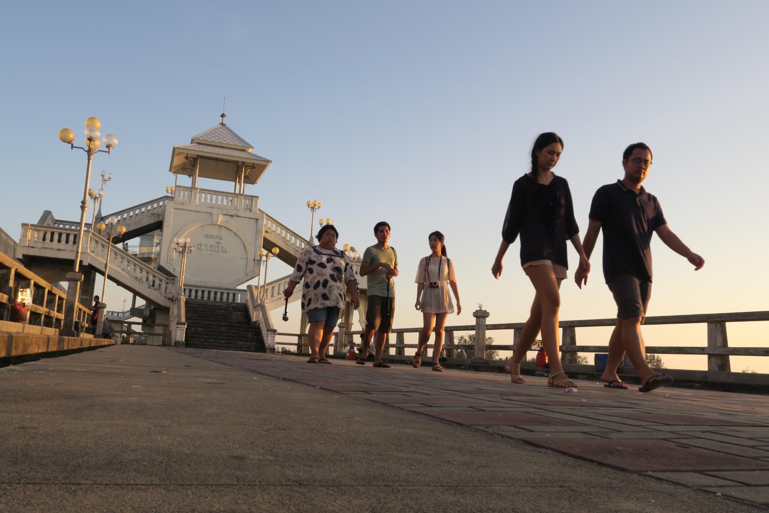 Locals are seen walking on Sarasin Bridge in Phuket, which is a landmark of the island, and may be the venue for the countdown celebration. Sarod Meewongsom