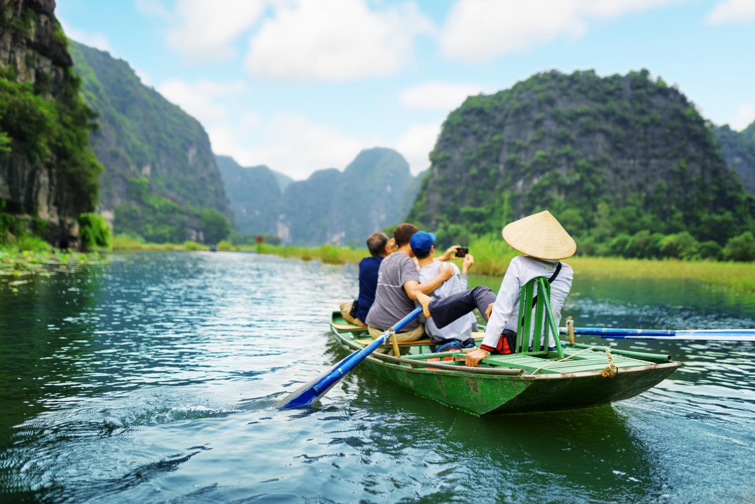 Tourists enjoy the scenery from a boat on the Ngo Dong River in Ninh Binh province, about 80 kilometres south of Hanoi. 123RF