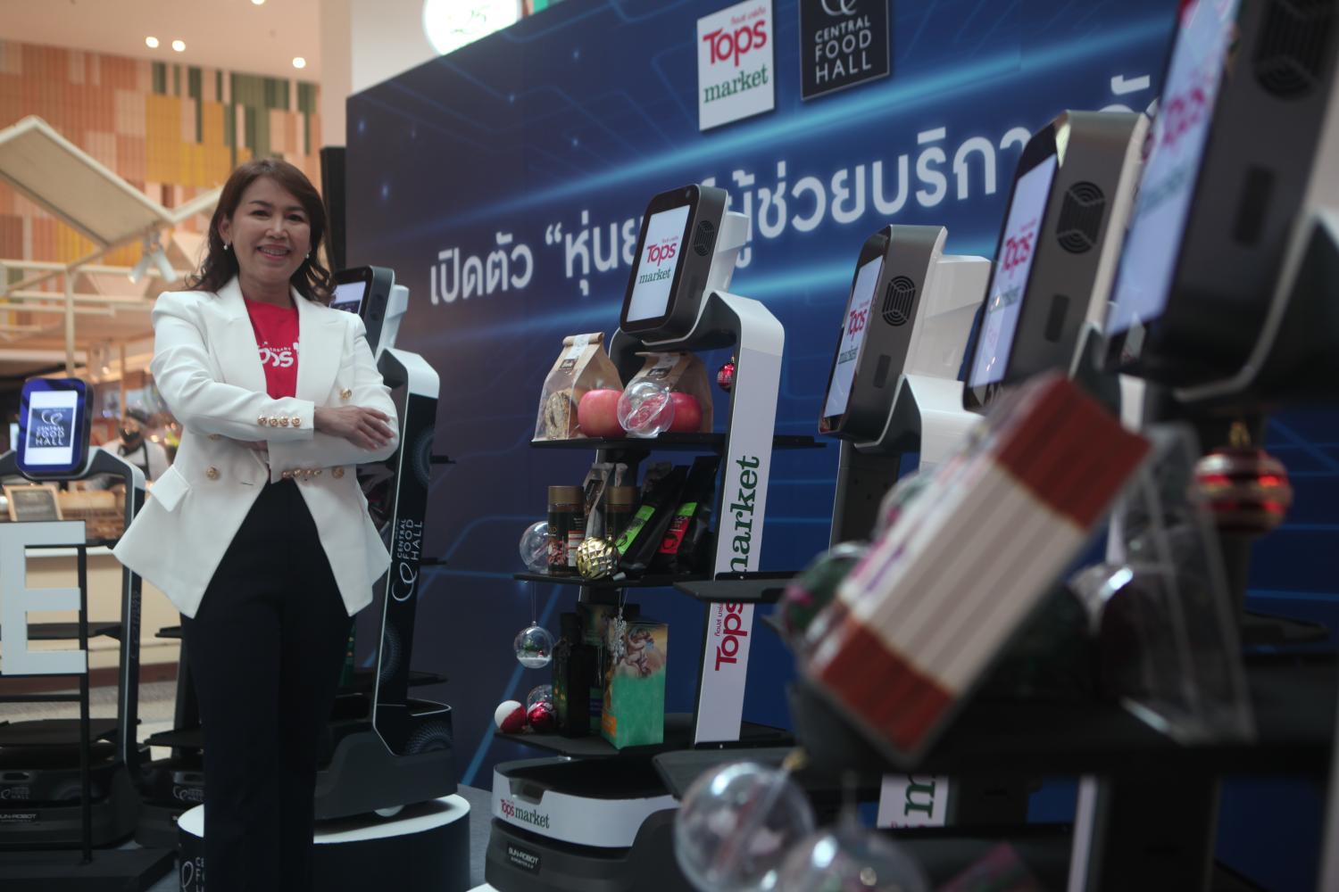 Ms Sujita promotes the Temjai AI service robots at Central Food Hall in CentralWorld. Apichart Jinakul