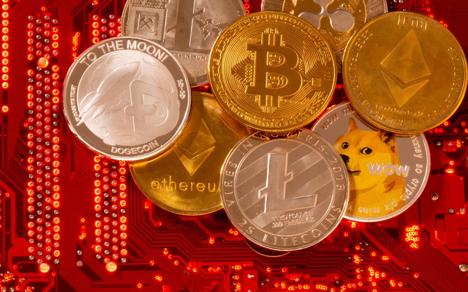 Representations of cryptocurrencies Bitcoin, Ethereum, DogeCoin, Ripple and Litecoin on a PC motherboard in an illustration taken on June 29. REUTERS