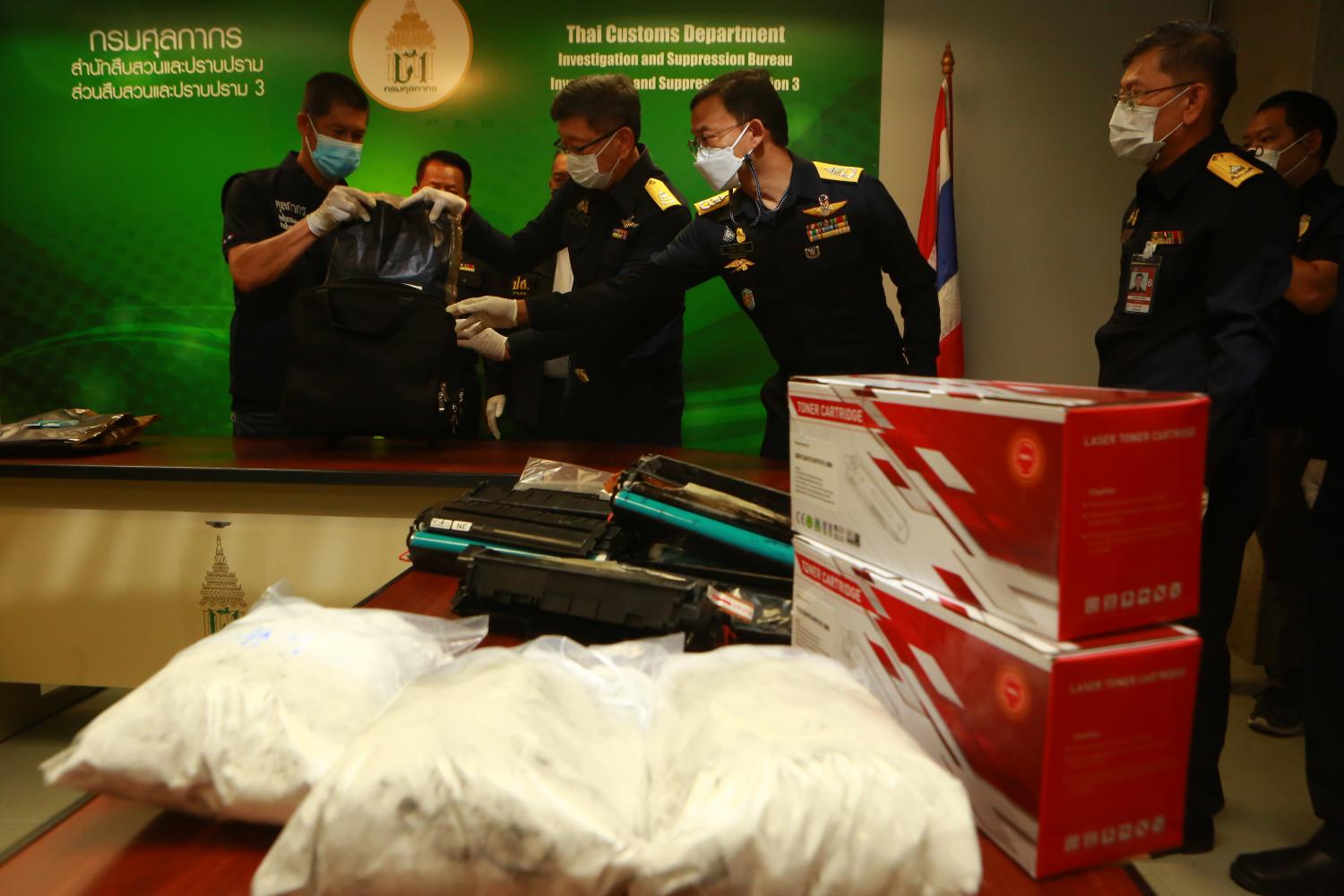 Big haul: The Customs Department displays 4kg of cocaine valued at 12 million baht after a 26-year-old Thai woman was found carrying the drug in her backpack from Dubai. Together with the Airport Interdiction Task force it also seized 4,270 grammes of crystal meth, valued at 3 million baht.