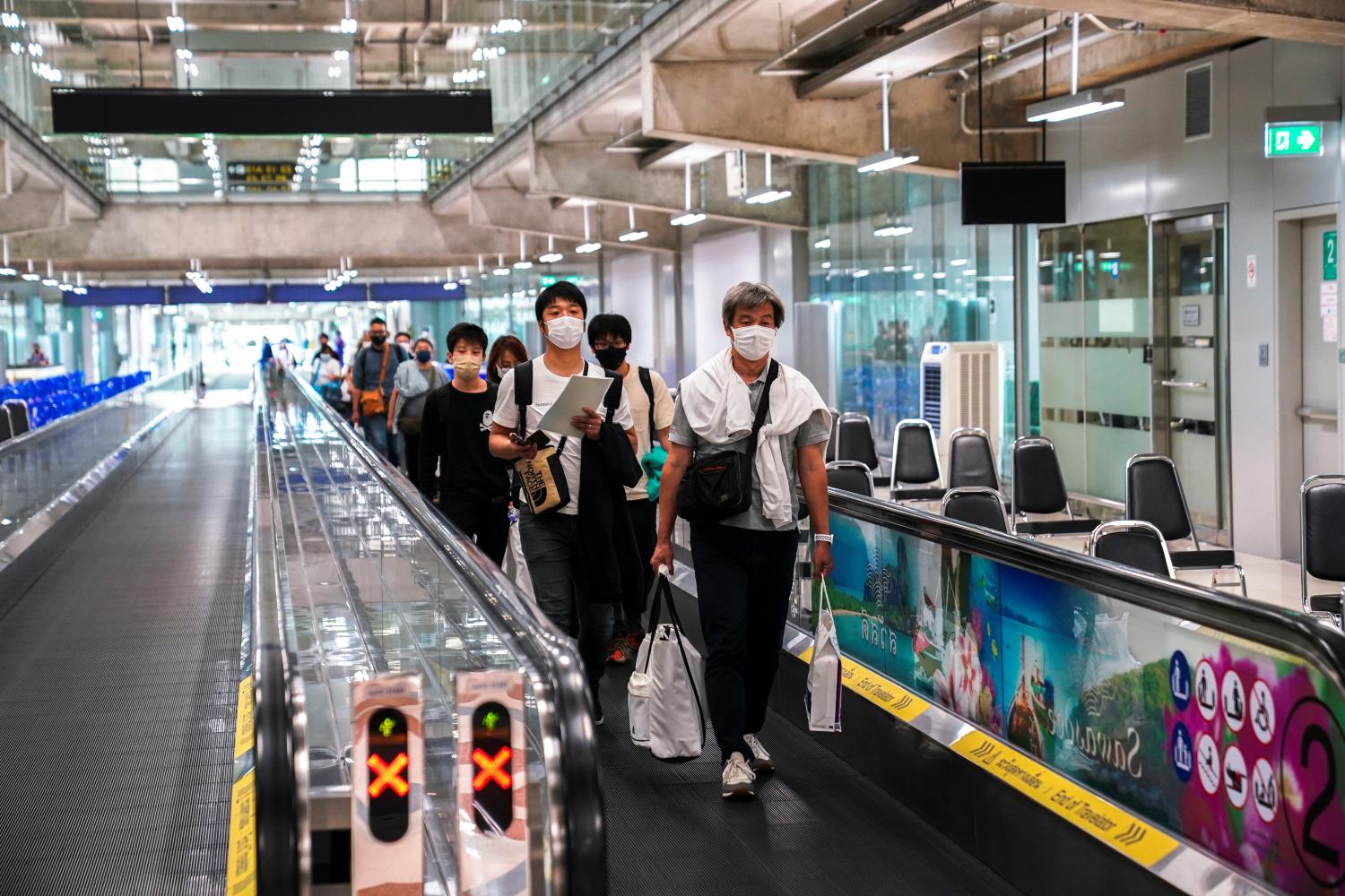 Foreign tourists arrive at Suvarnabhumi airport on the first day of the country's reopening, Nov 1. REUTERS