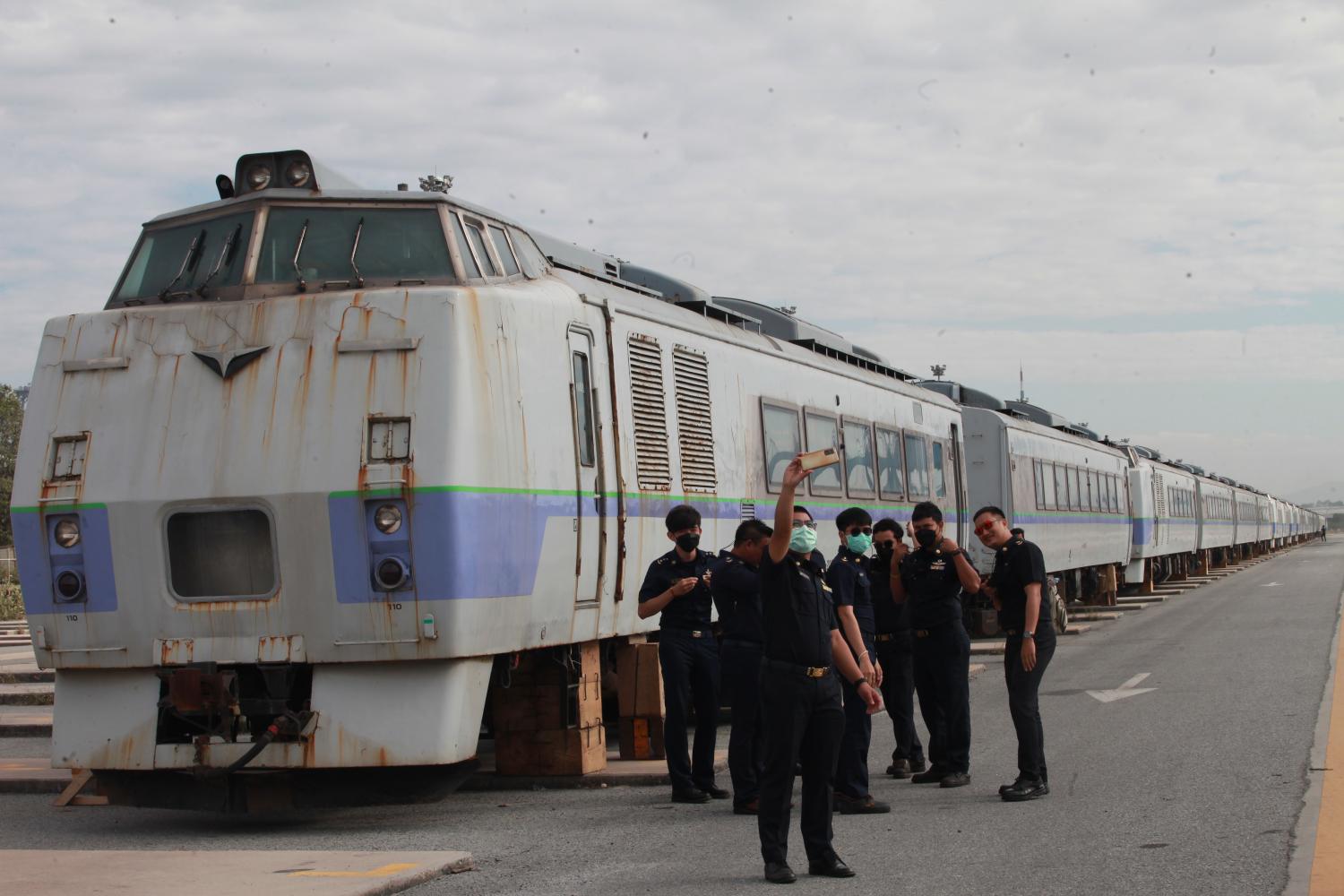 State Railway of Thailand staff take a selfie with train carriages donated by Japan which arrived at Laem Chabang port in Chon Buri on Monday.  (Photo: Apichart Jinakul)