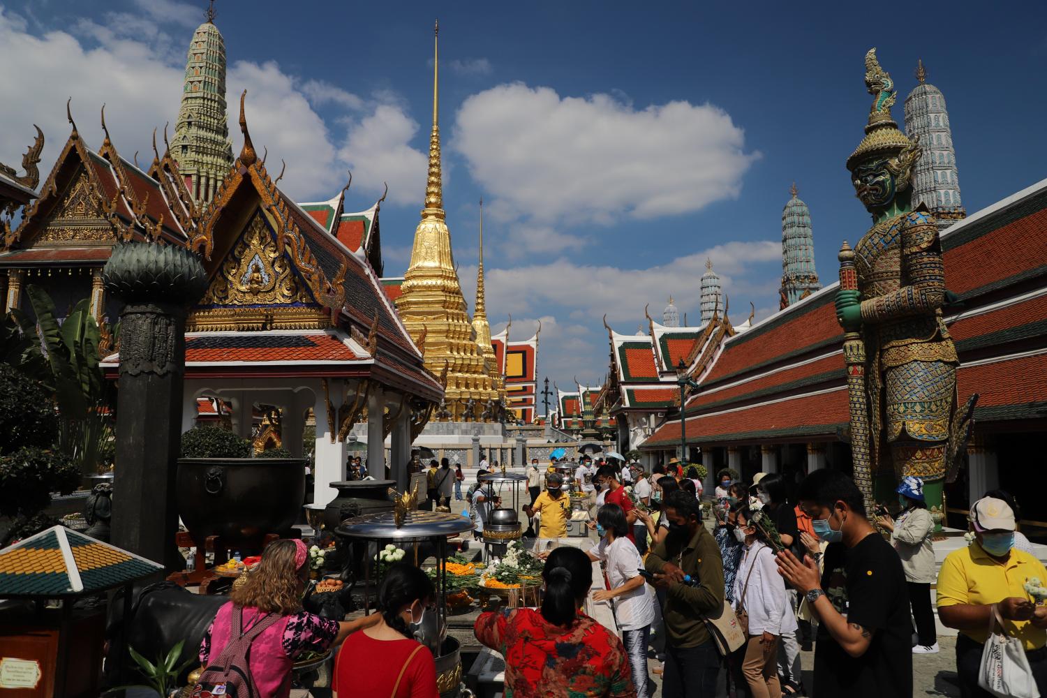 hustle and bustle: People flock to the Grand Palace and the Temple of the Emerald Buddha at New Year to make merit and pray. Royal calendars were distributed at the Grand Palace to visitors who sign a book to wish Their Majesties the King and Queen a happy New Year.