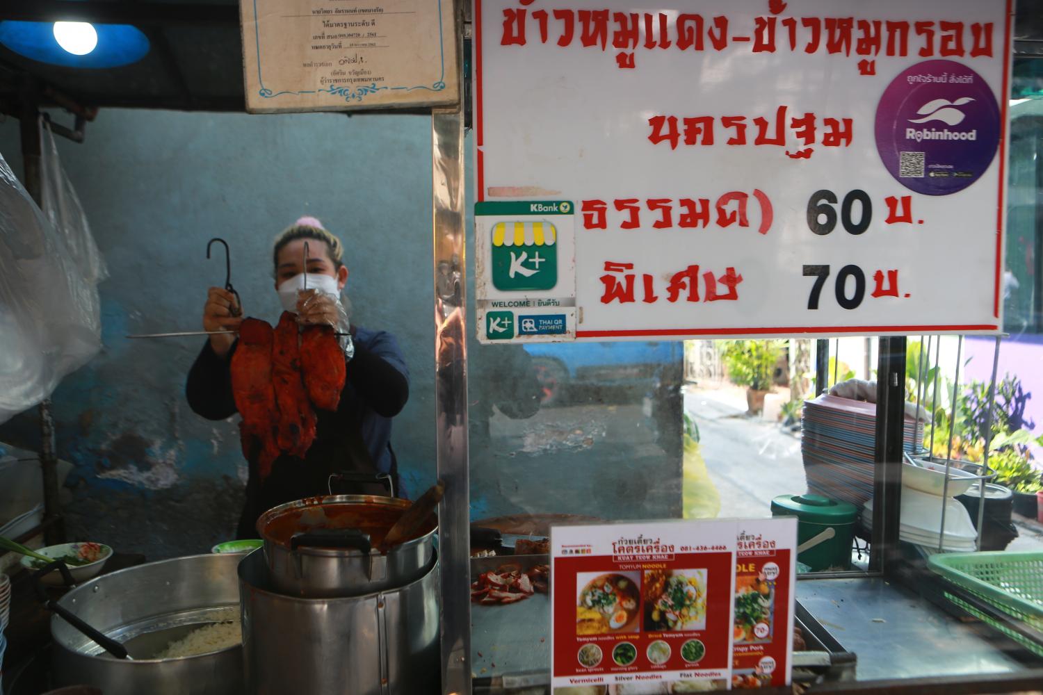 Food vendors along Silom Road on Wednesday adjusted their food prices by 5-10 baht, following a surge in the price of pork and other food products. (Photo: Somchai Poomlard)