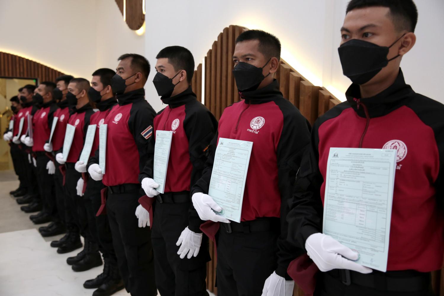 Officials tasked with forestry protection and fighting wildfires receive life insurance policy certificates. They were among more than 4,000 officials presented with certificates by the Ministry of Natural Resources and Environment on Monday. (Photo: Chanat Katanyu)