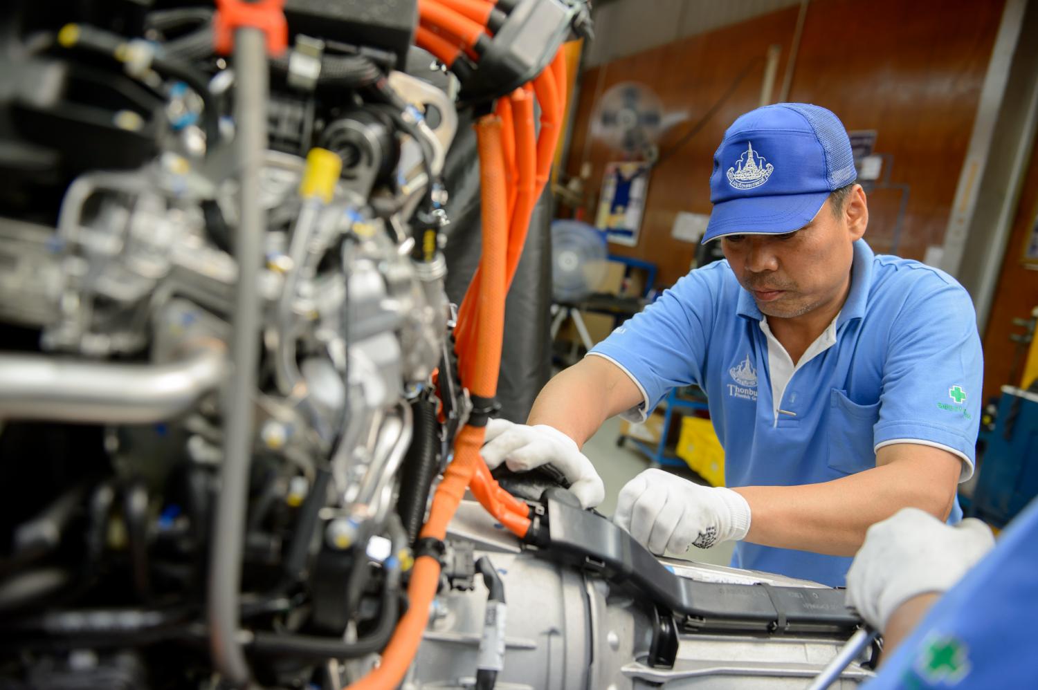 An engineer assembles auto parts at a manufacturing plant in Thailand.